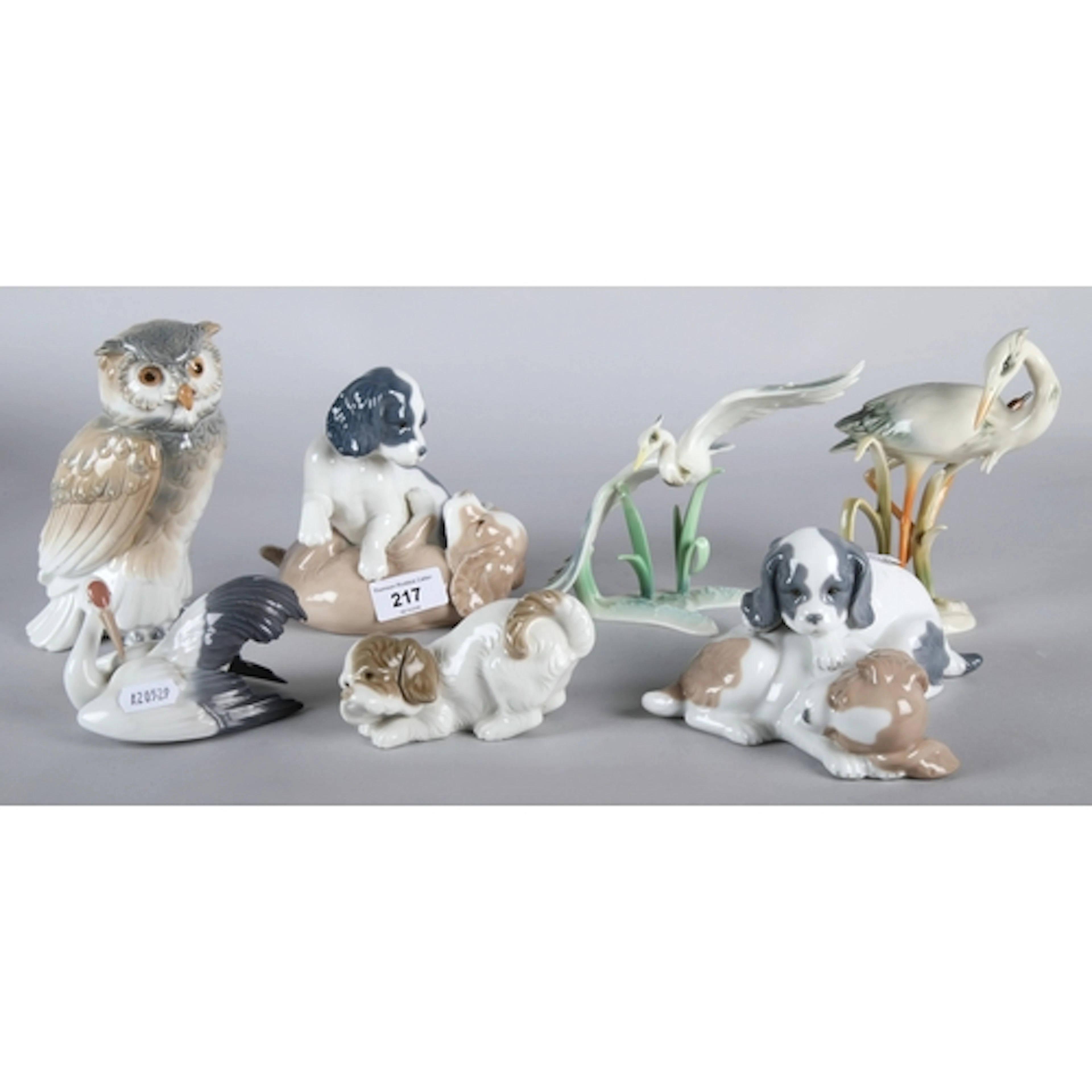 Collection of figures to include Nao, models of puppies, owl...