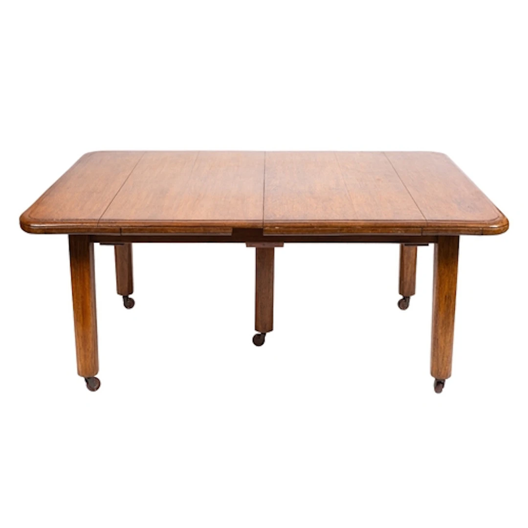 An oak extending dining table, early 20th century; the recta...