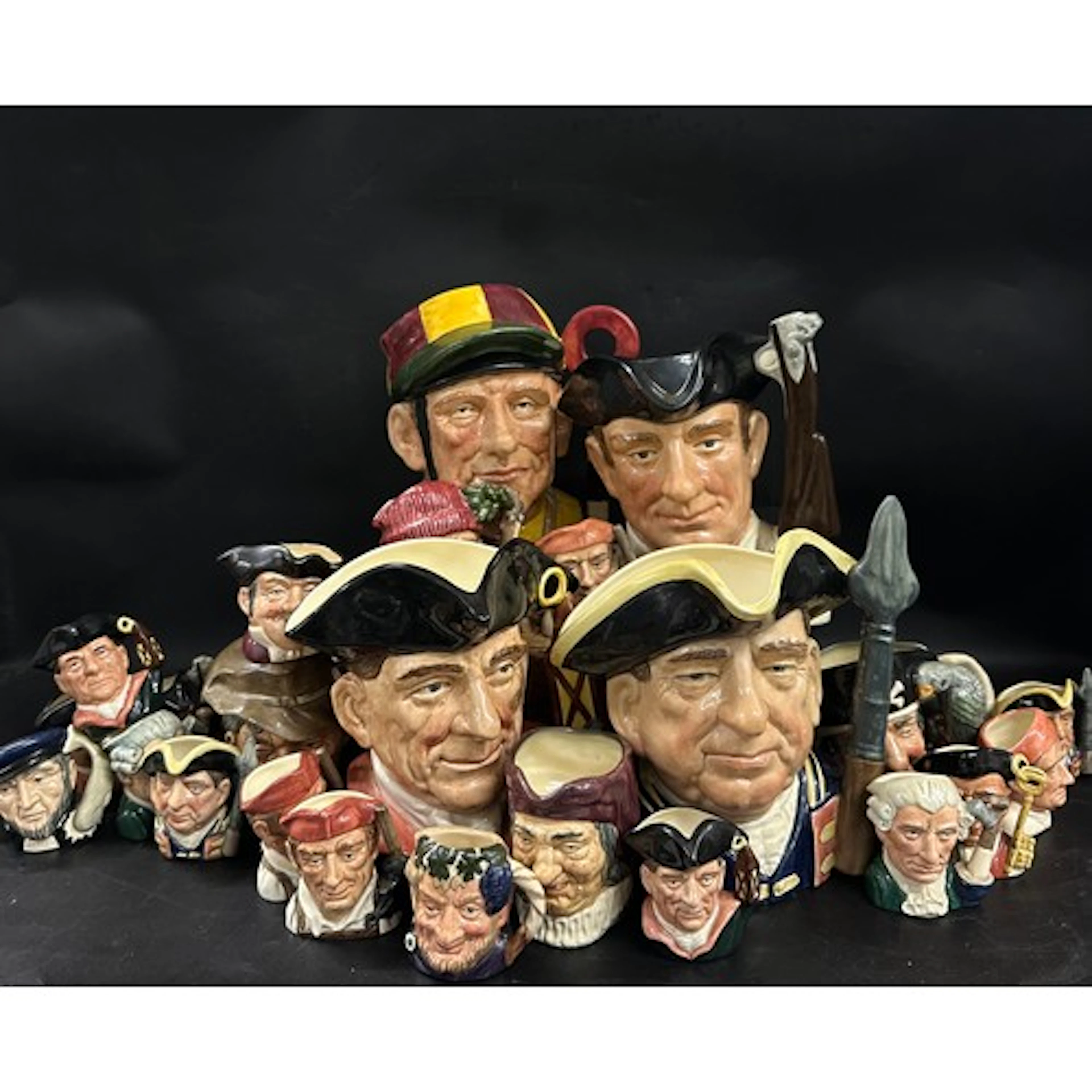 A collection of Royal Doulton character jugs, four large and...