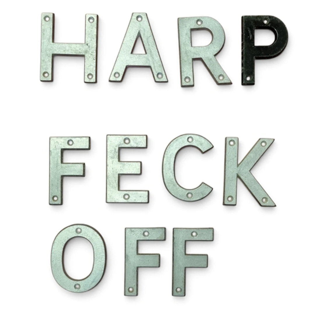 A collection of vintage aluminium letters spelling 'HARP' an...