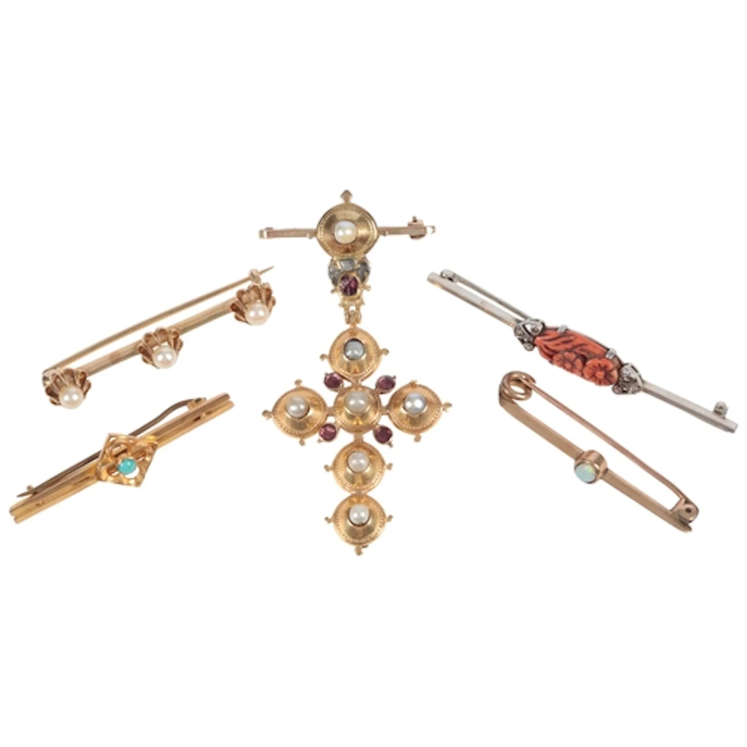 Four bar brooches and a cross pendant brooch, early 20th cen...