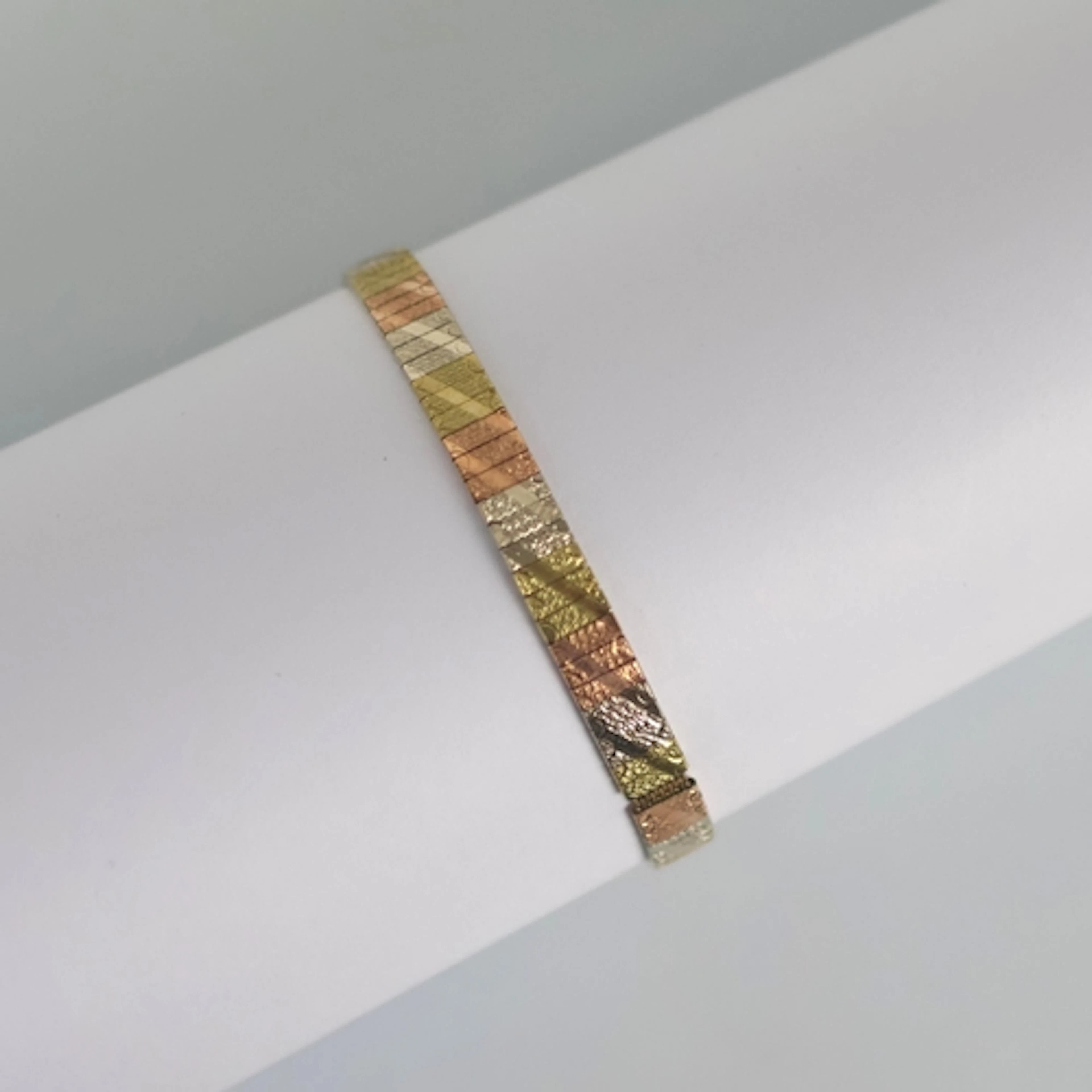 A late 20th century Italian bracelet, the three tone bracele...