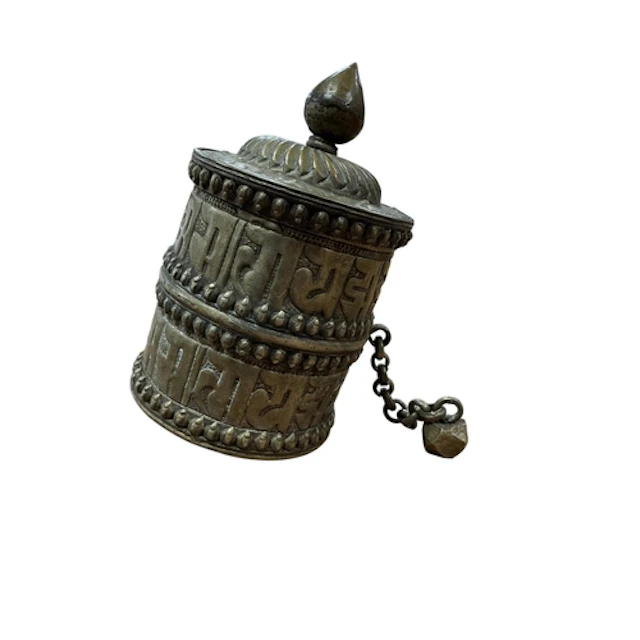 A Tibetan embossed prayer wheel, 12cm high