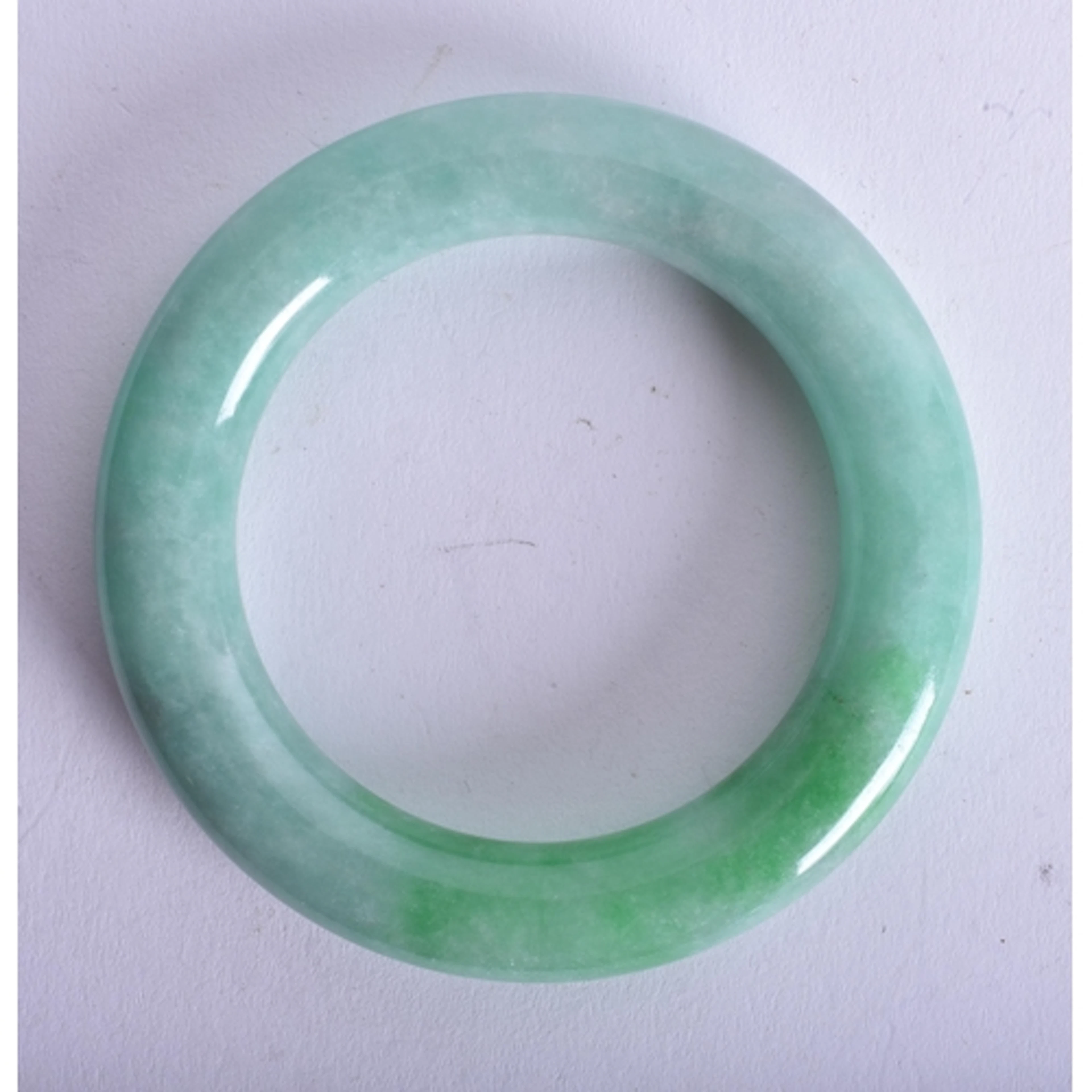 A Green Jade Bangle. 5.6cm internal diameter, weight 96g
