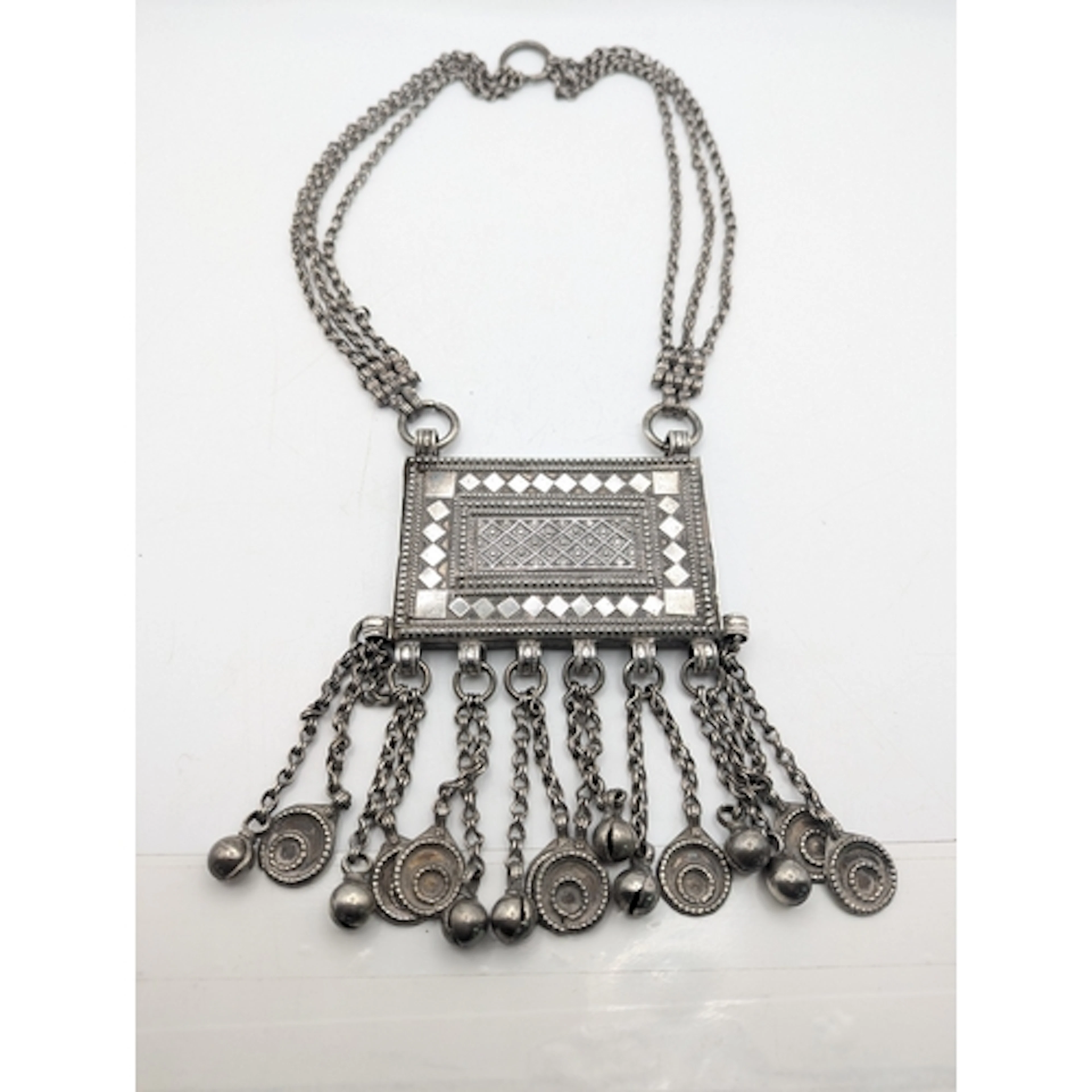 A silver and white metal Omani Hirz amulet necklace with a g...