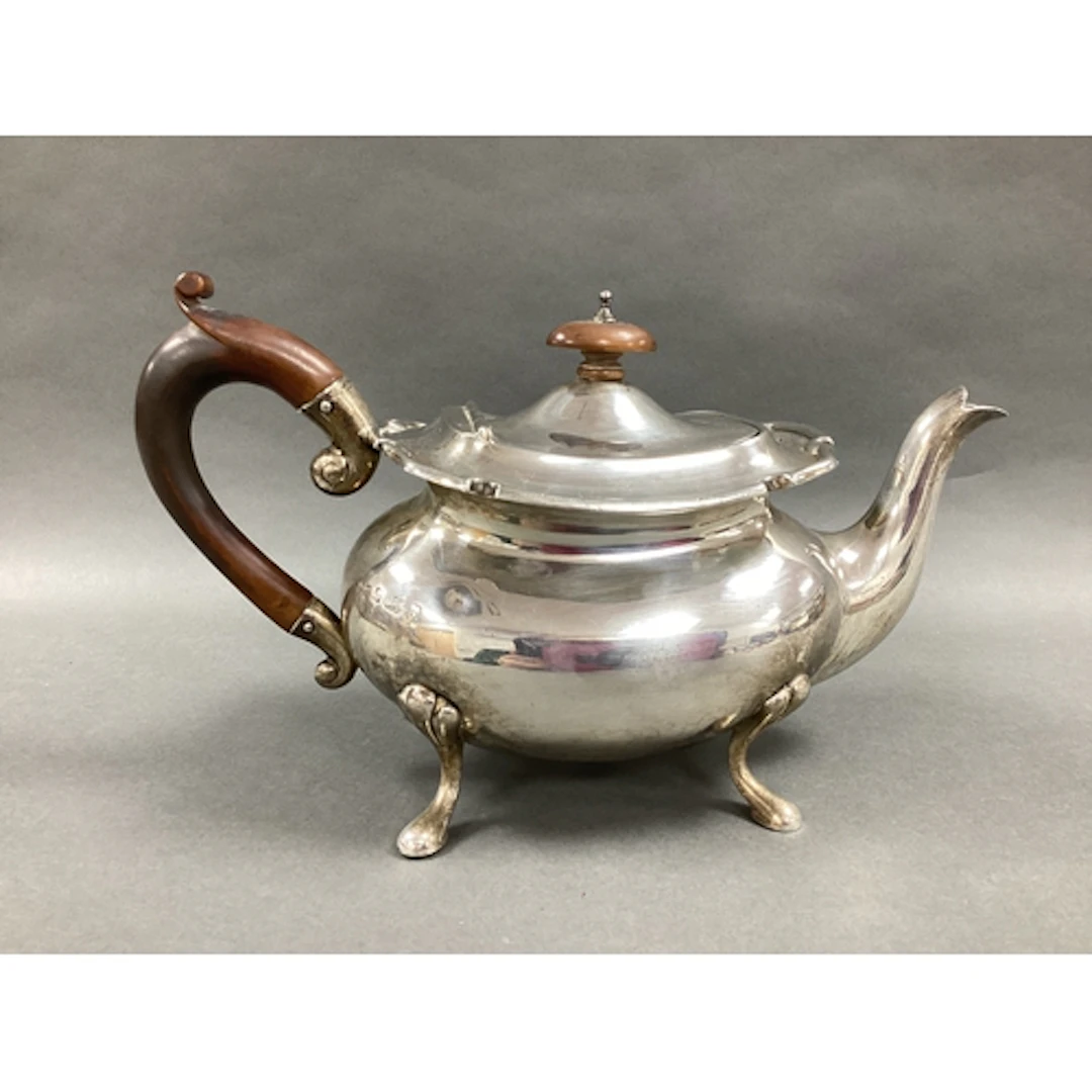 A Hallmarked Silver Teapot, of baluster form (dented), with ...