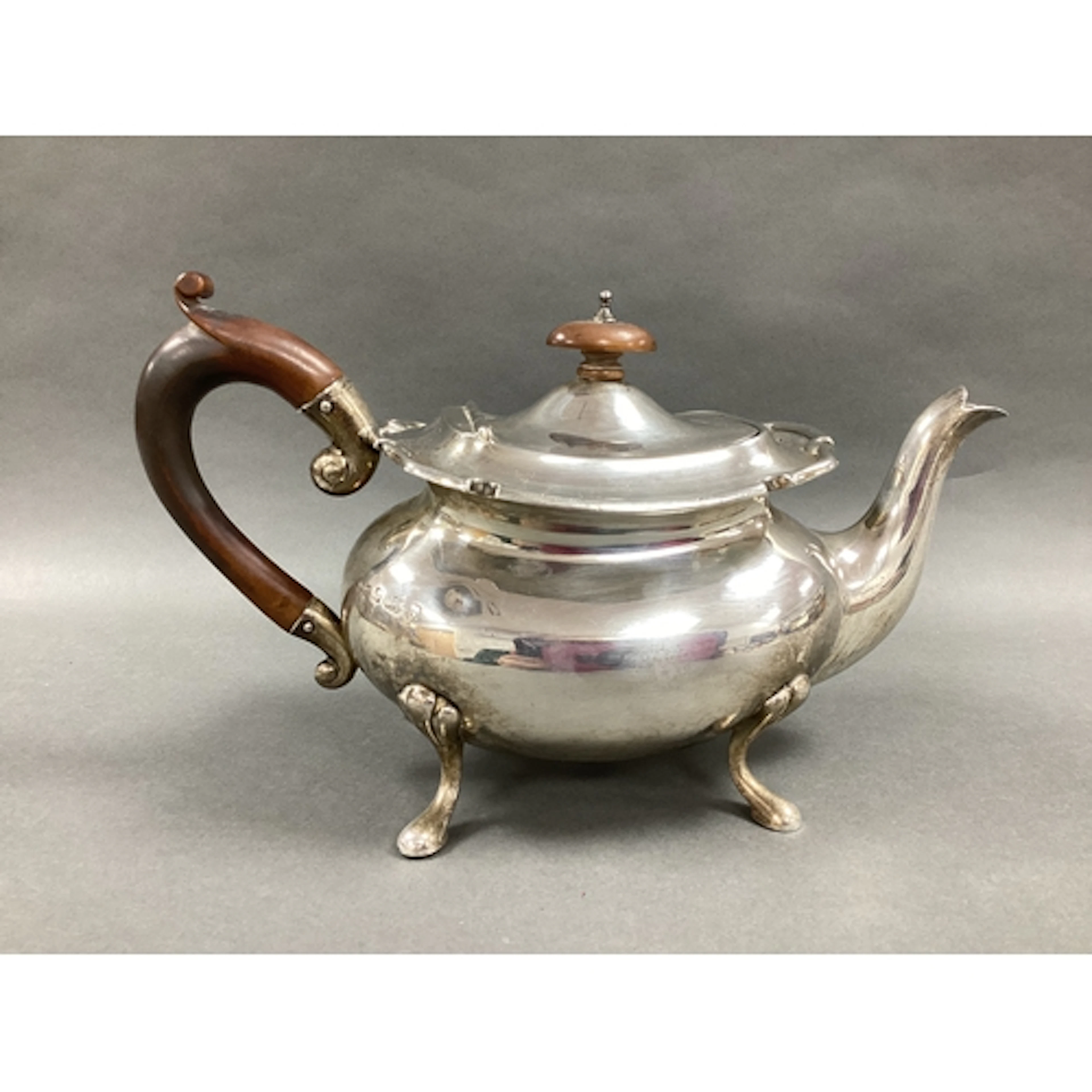 A Hallmarked Silver Teapot, of baluster form (dented), with ...