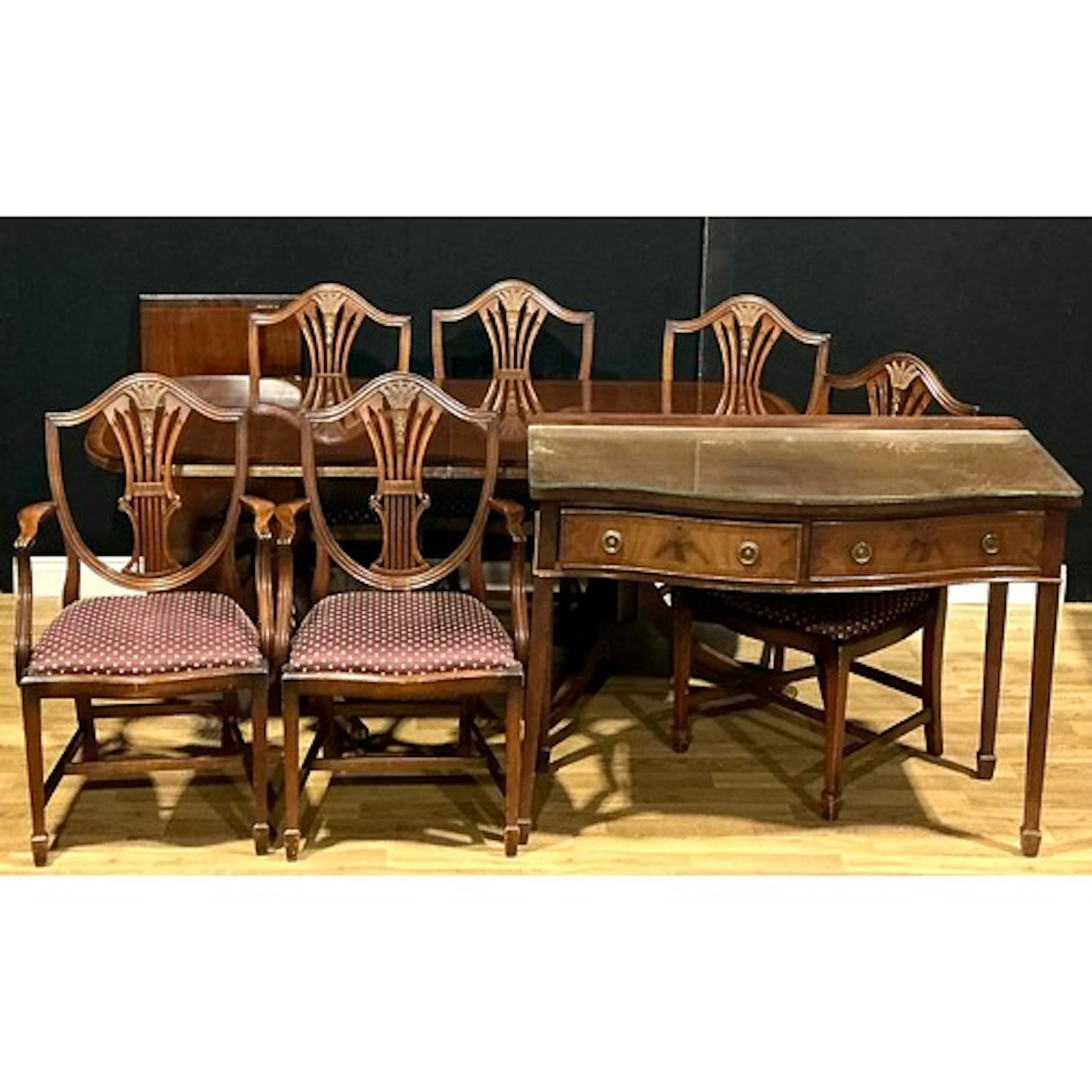 A Regency style extending dining table; a set of seven dinin...
