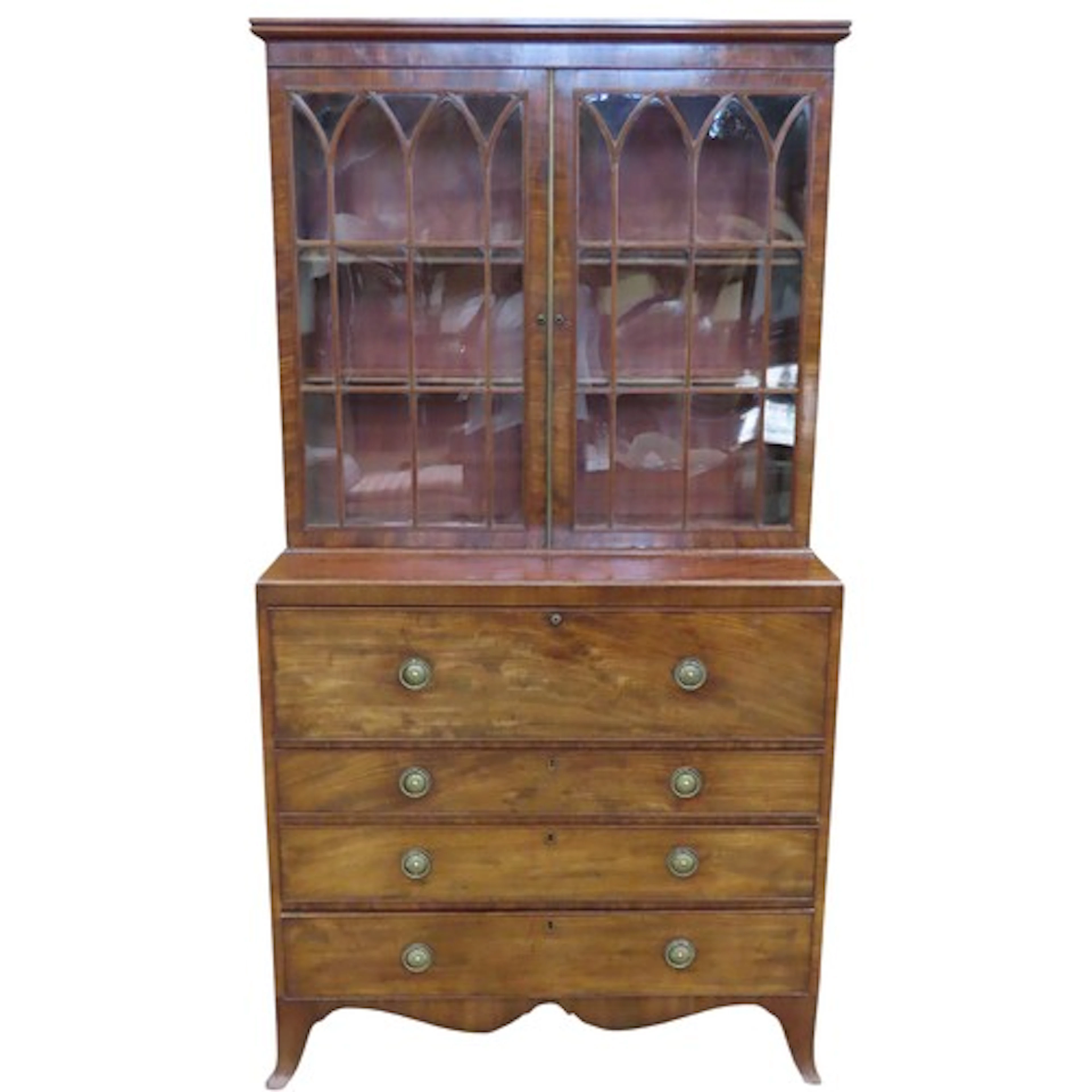A Regency mahogany secretaire bookcase in two sections, the ...