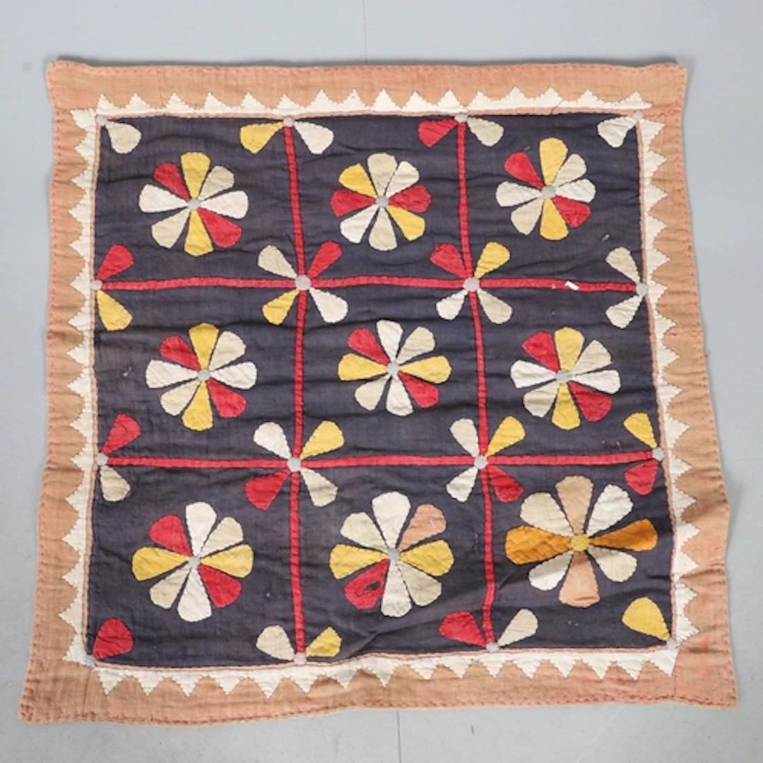 A PANEL OF COTTON APPLIQUE. early 20th century, worked with ...