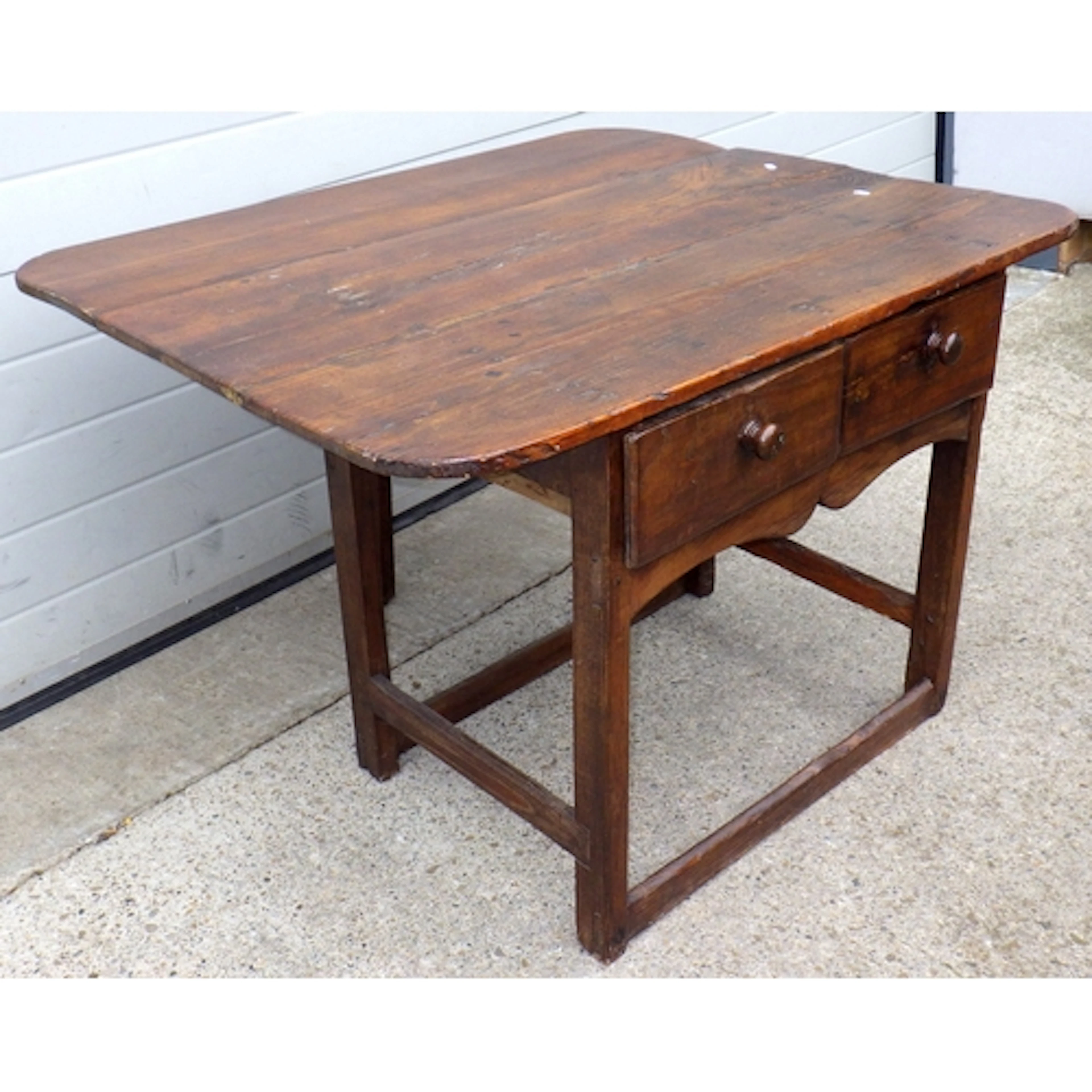 A two drawer oak side table with drop leaf at the back, 110c...