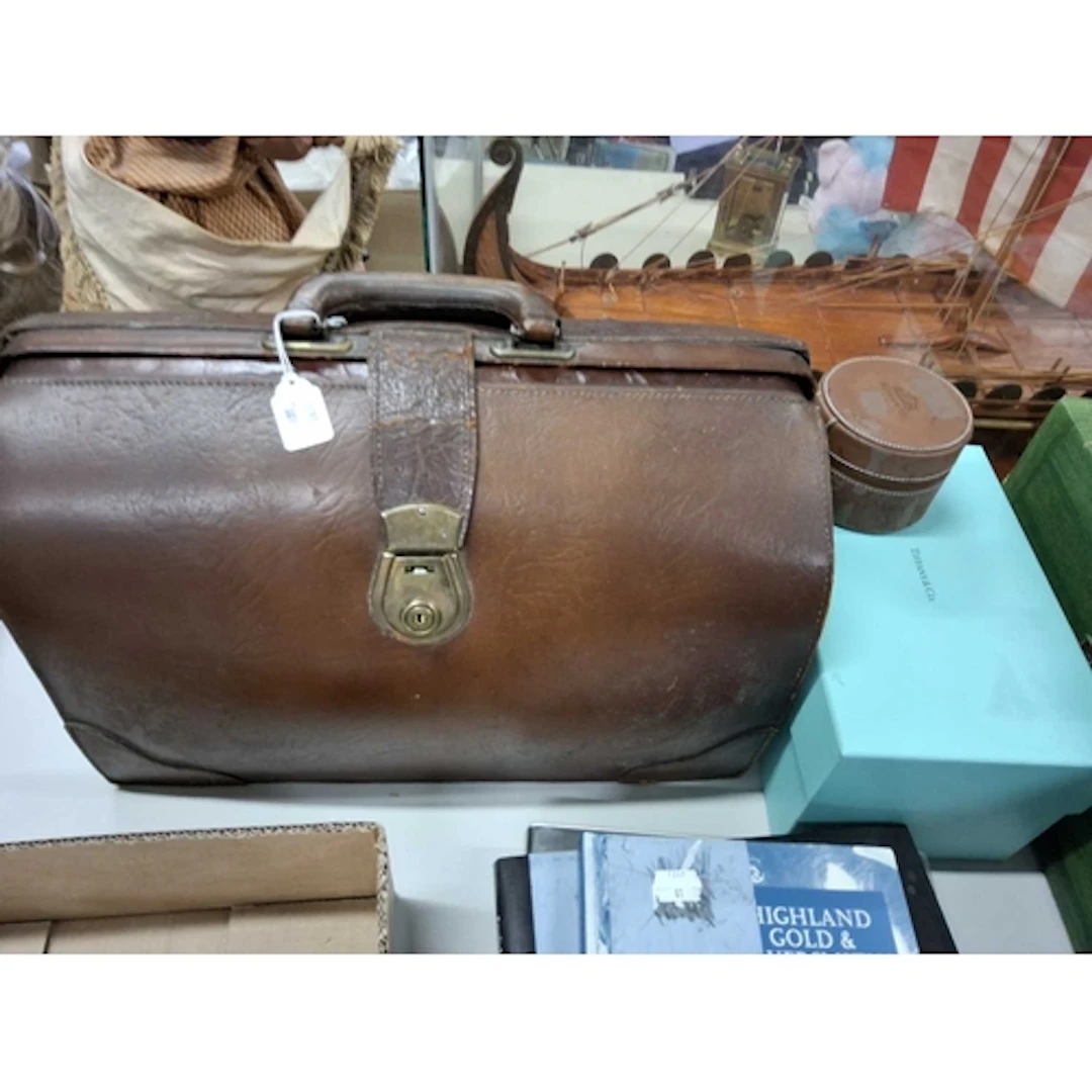 A VINTAGE LEATHER GLADSTONE DOCTOR'S BAG together with an em...