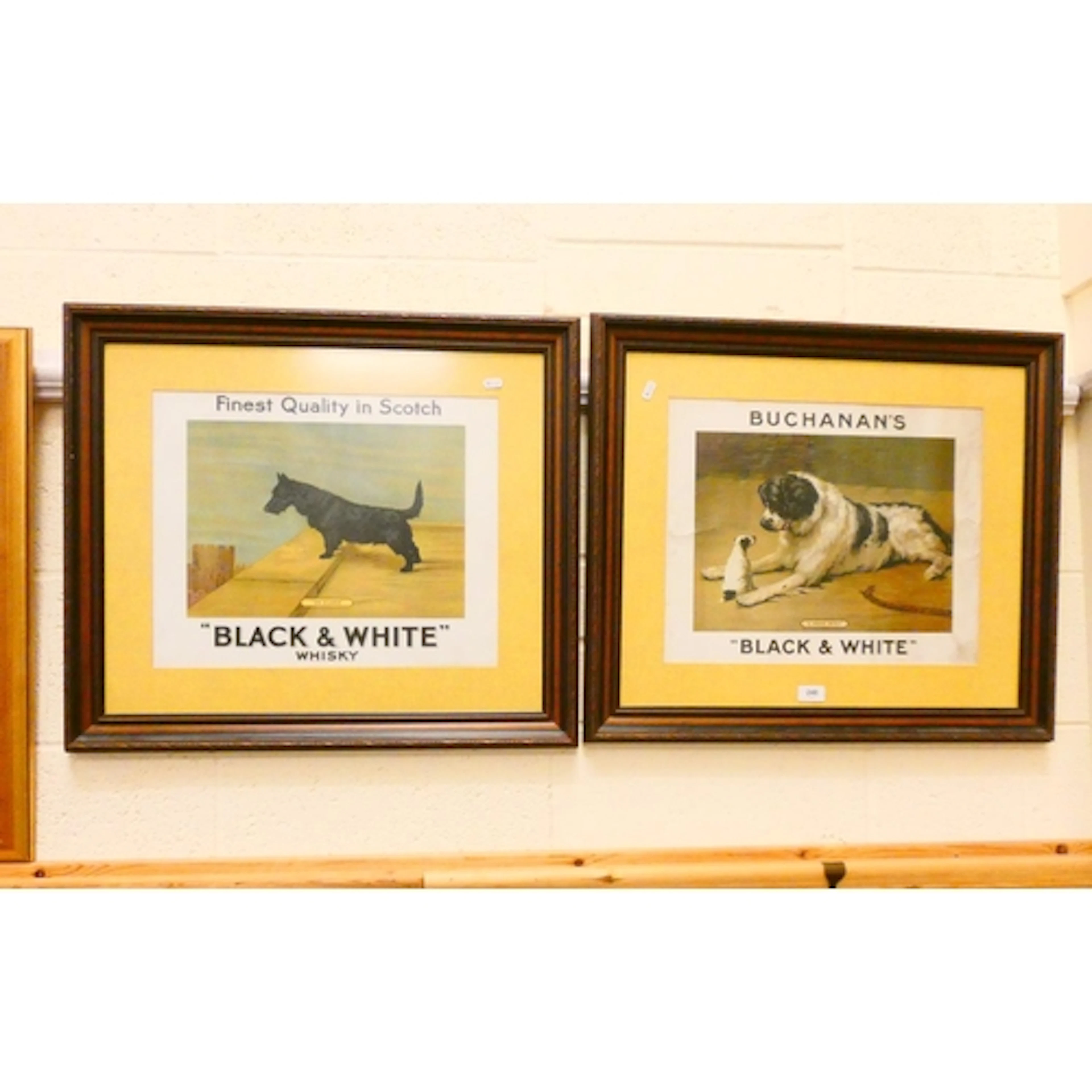 Two framed posters for Buchanan's Black & White Scotch W...
