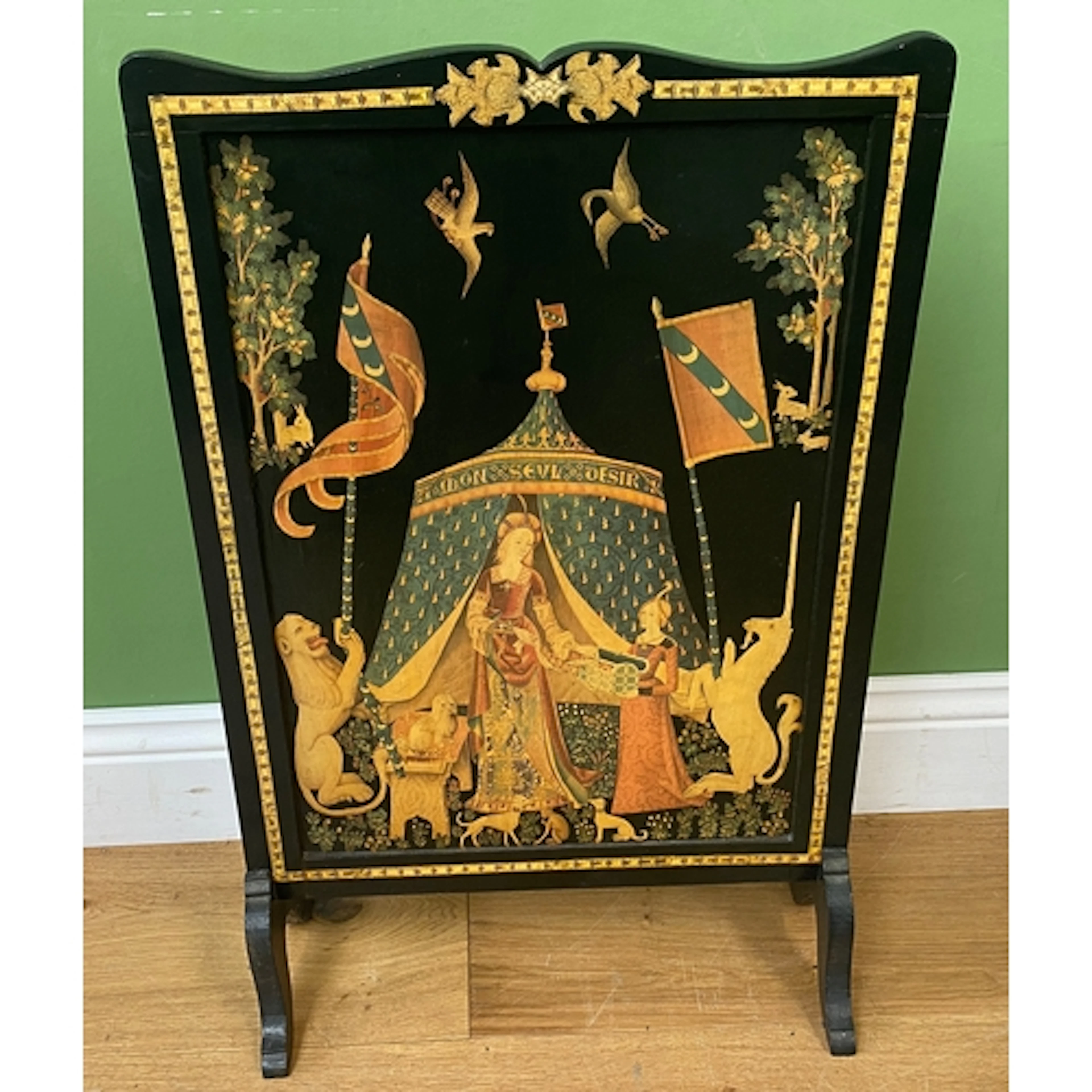 A black painted fire screen with transferware scene from The...