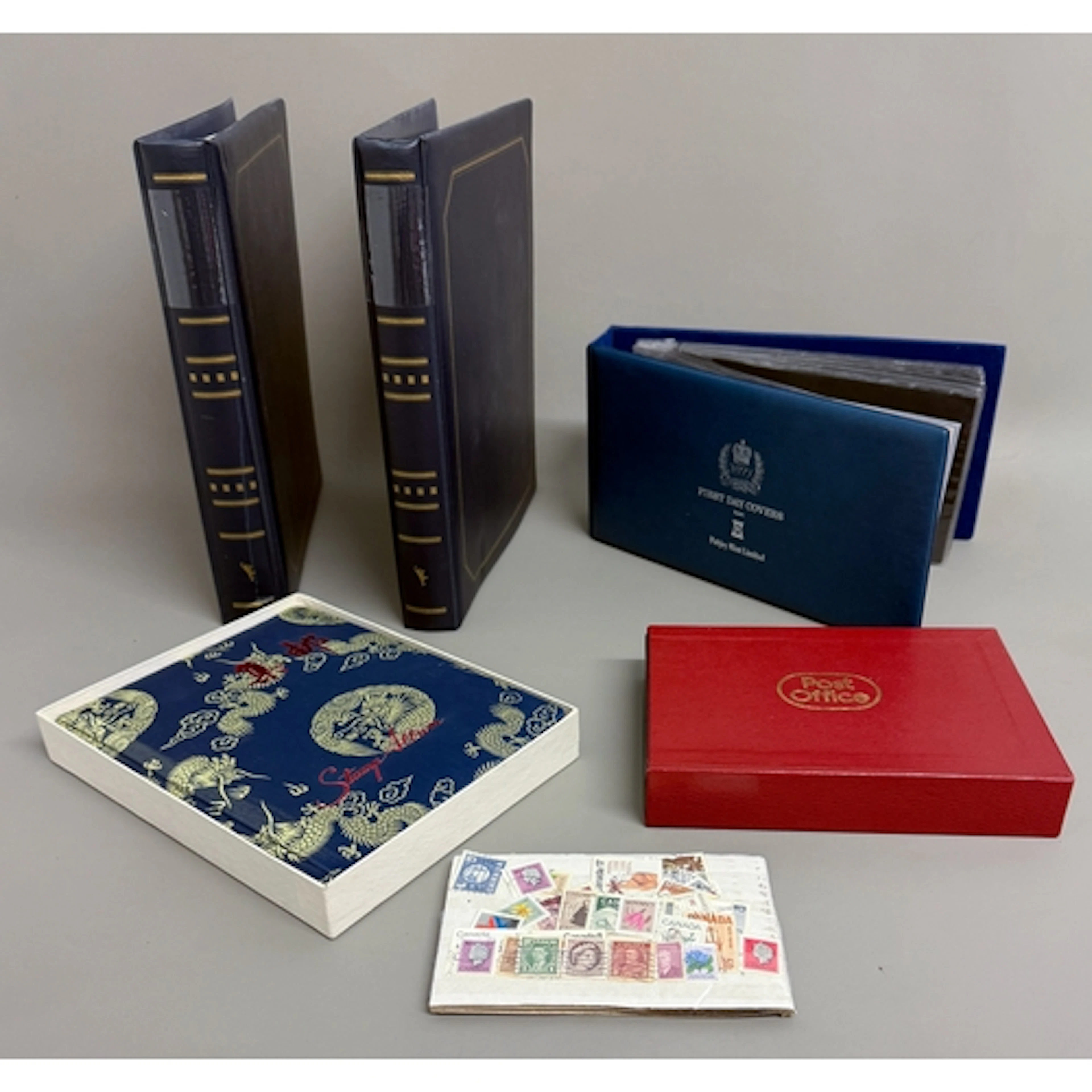 A mixed lot of stamps, FDCs and coin FDCS - 1. a three-albu...