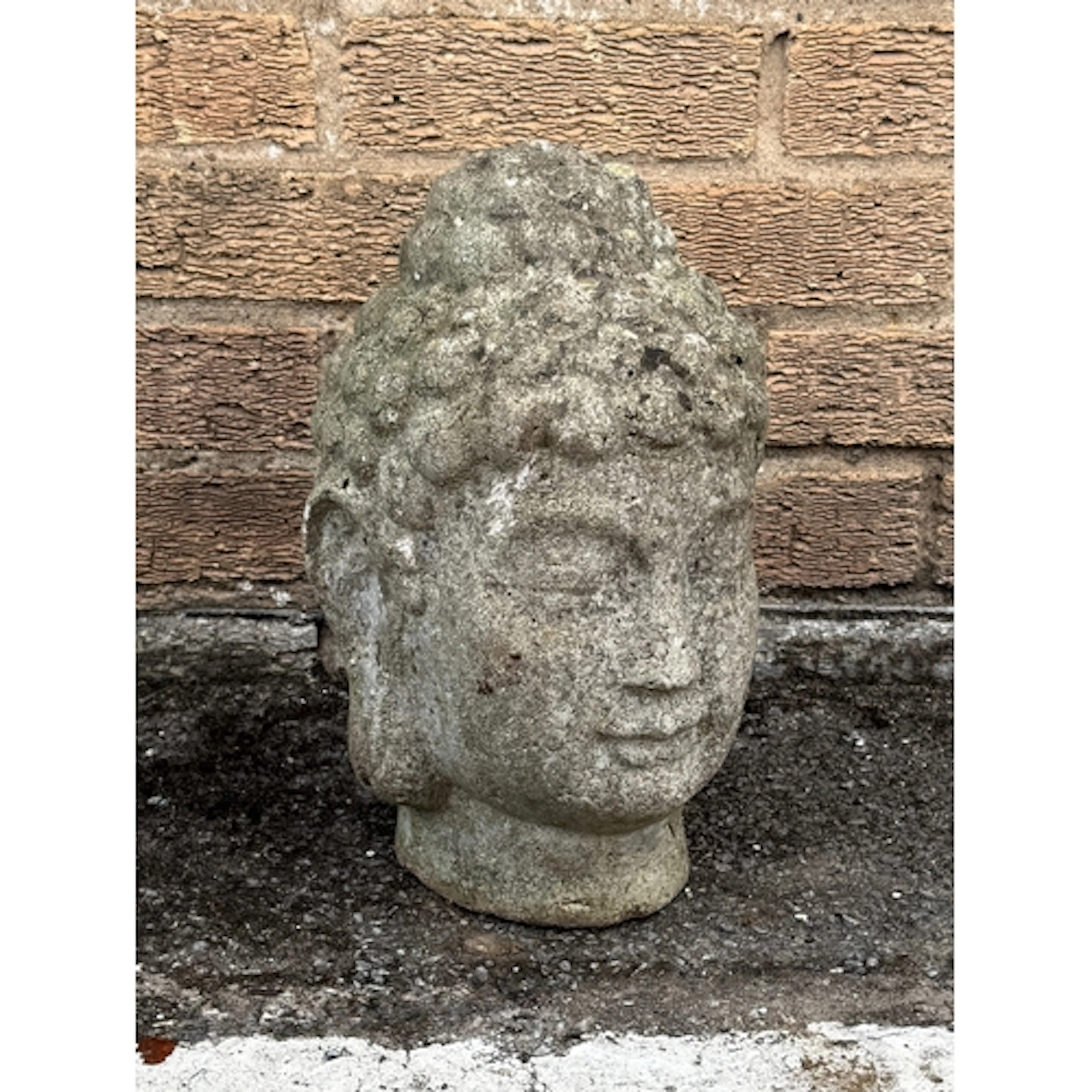 A small composite stone Buddha head garden ornament - 34cm h...