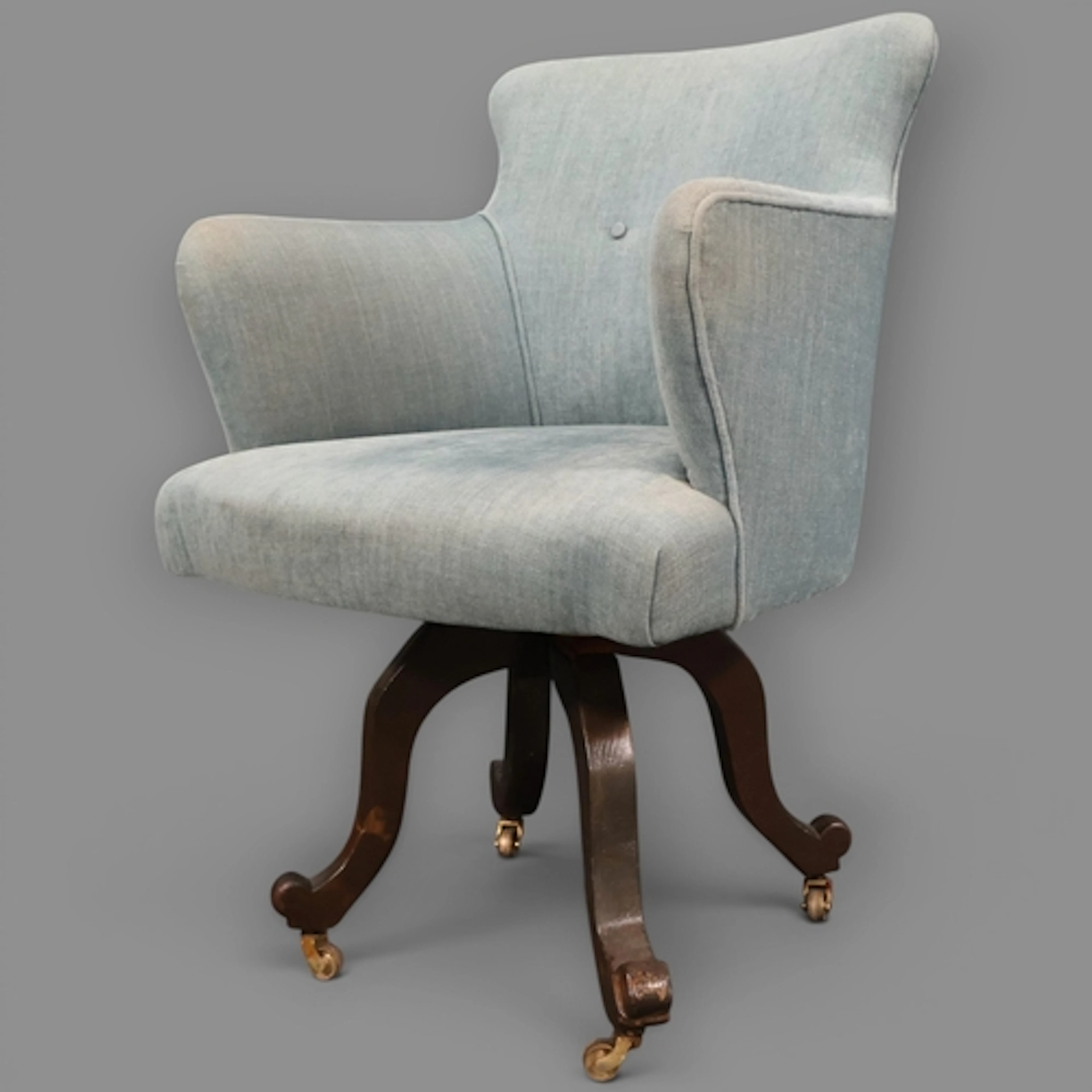 A Victorian oak and upholstered swivel desk chair with a W C...