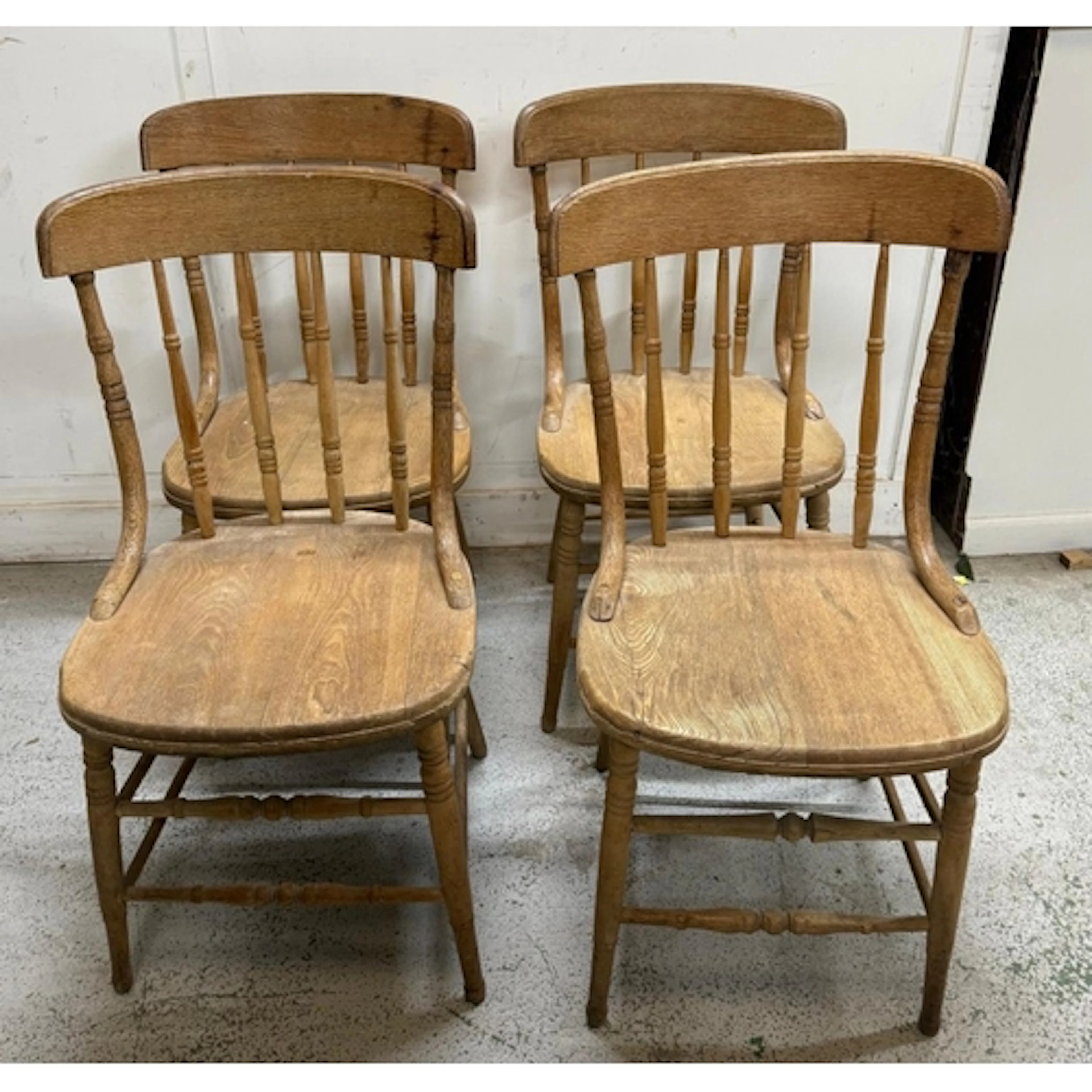 A set of four elm stick-back kitchen chairs