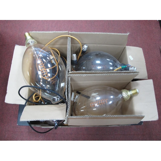 Three large IKEA branded oversized light bulbs together with...