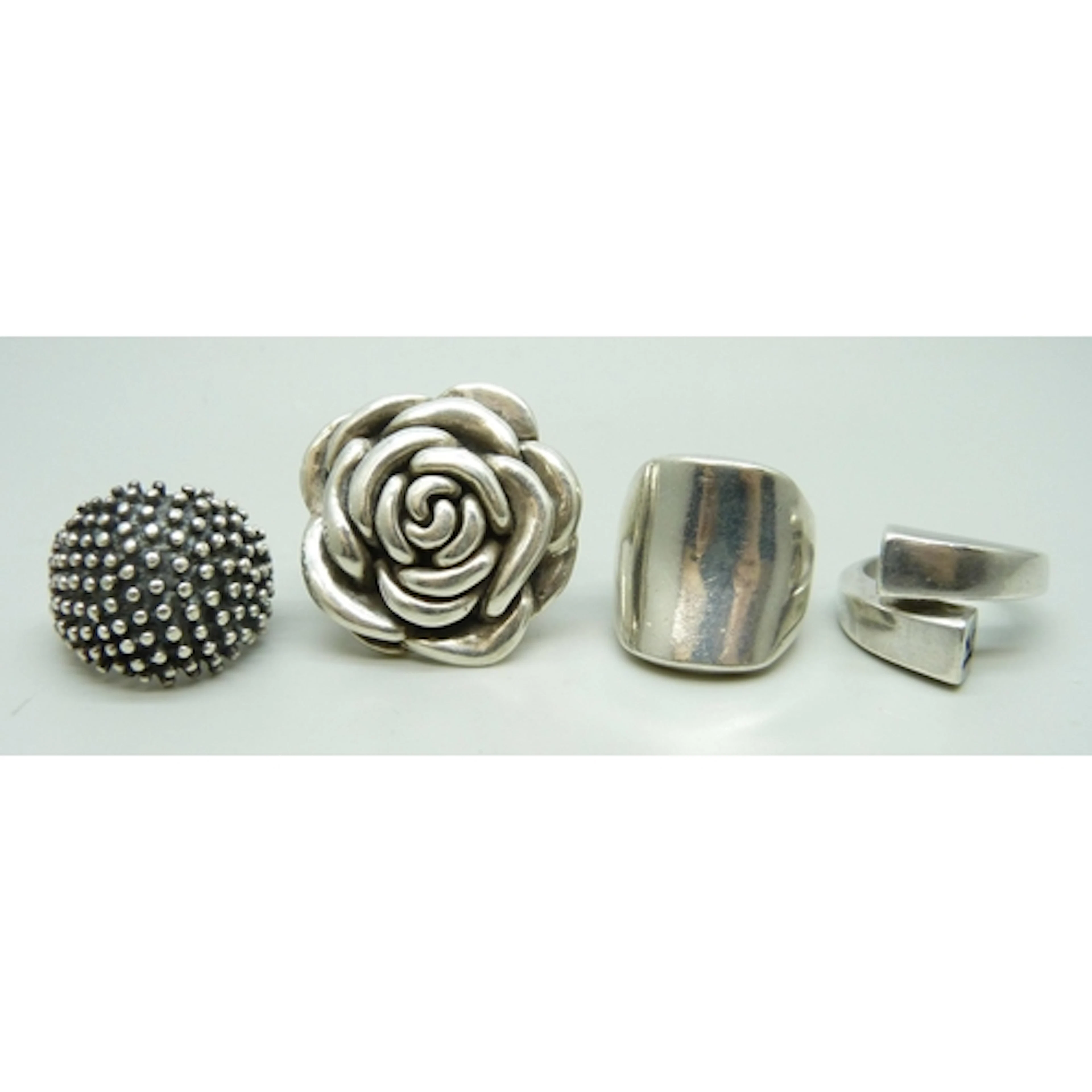 Four statement silver rings including Kenzo, 52g total, flow...