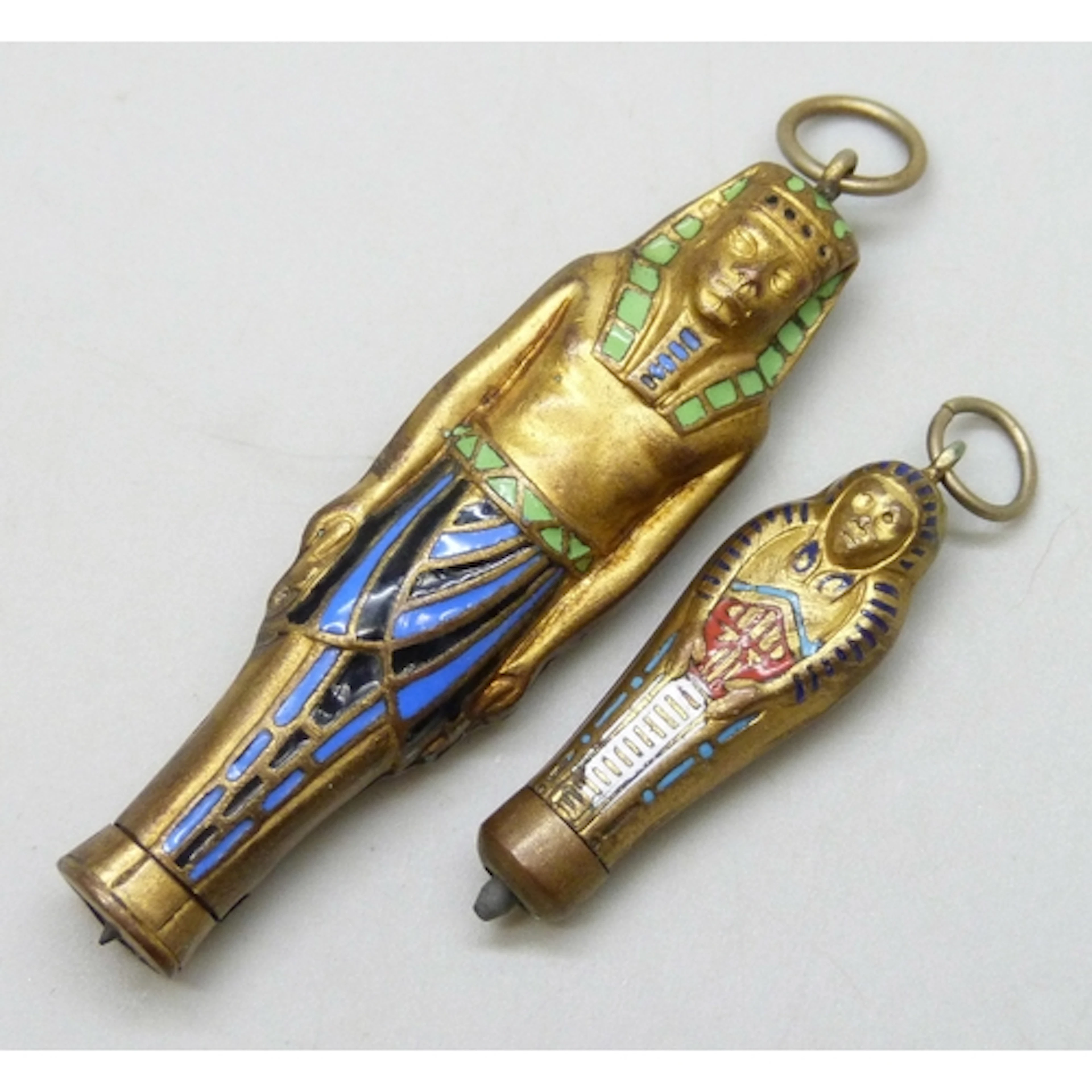 Two Egyptian sarcophagus pendant propelling pencils, largest...