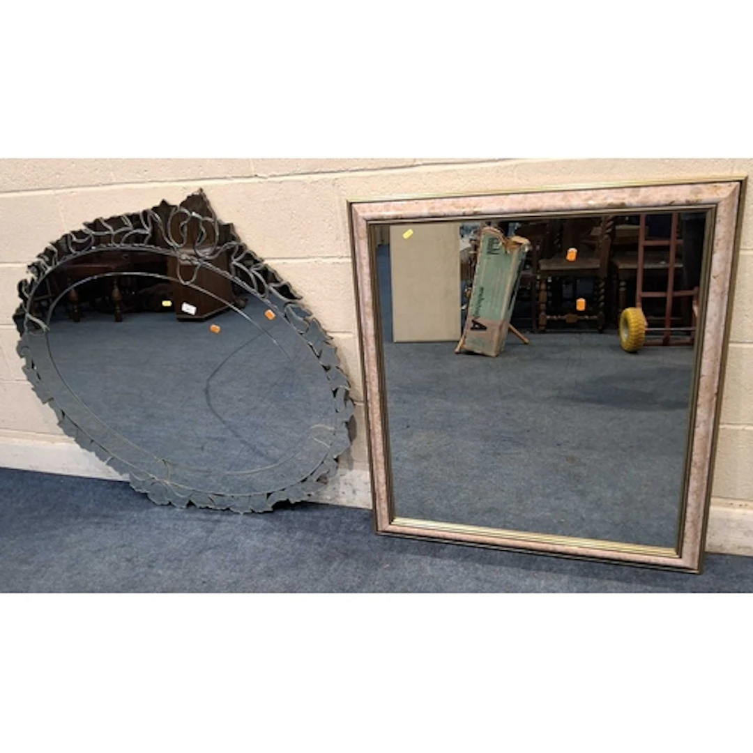 A LARGE OVAL FRAMELESS WALL MIRROR, with foliate designs, al...