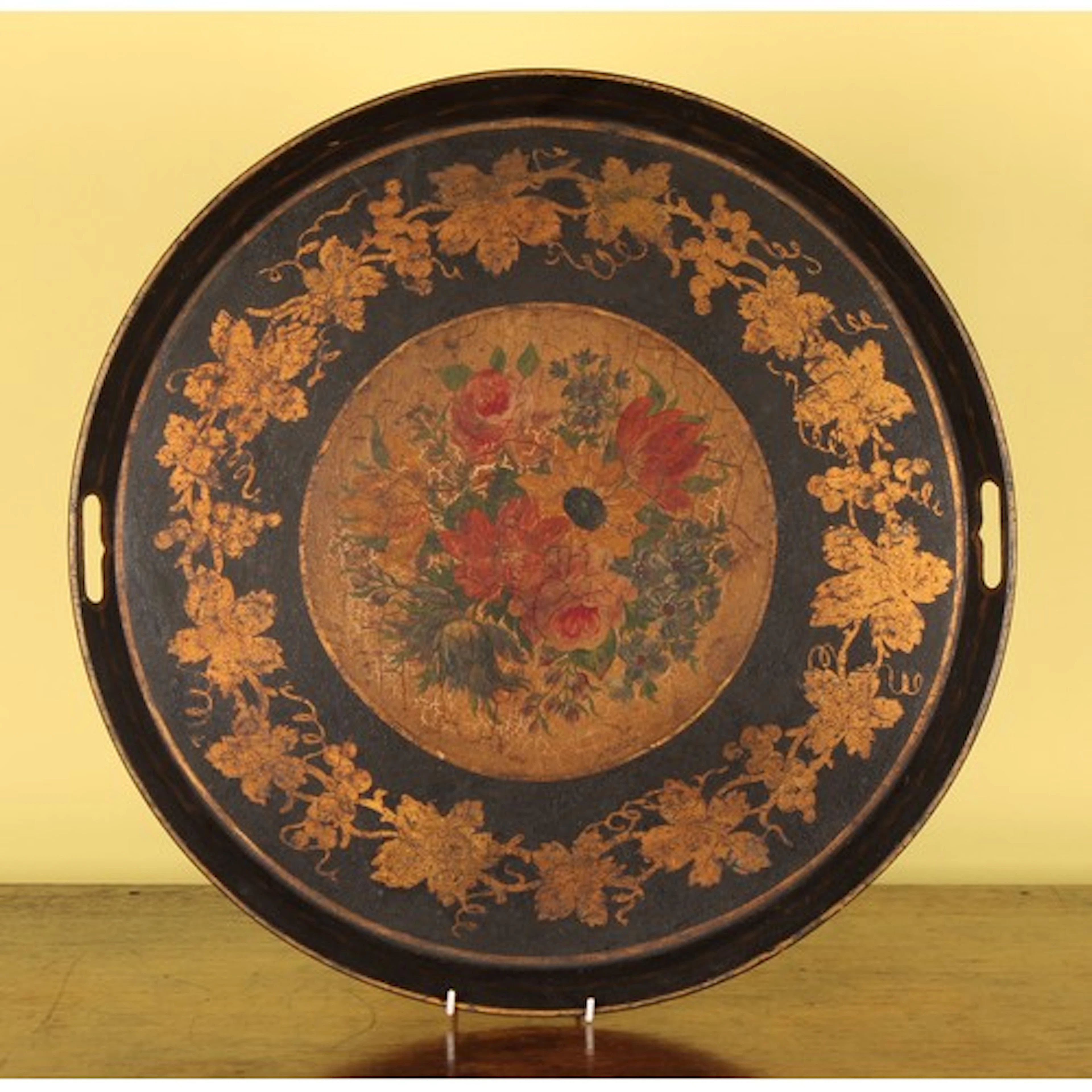 A 19th century toleware circular gallery tray, painted with ...