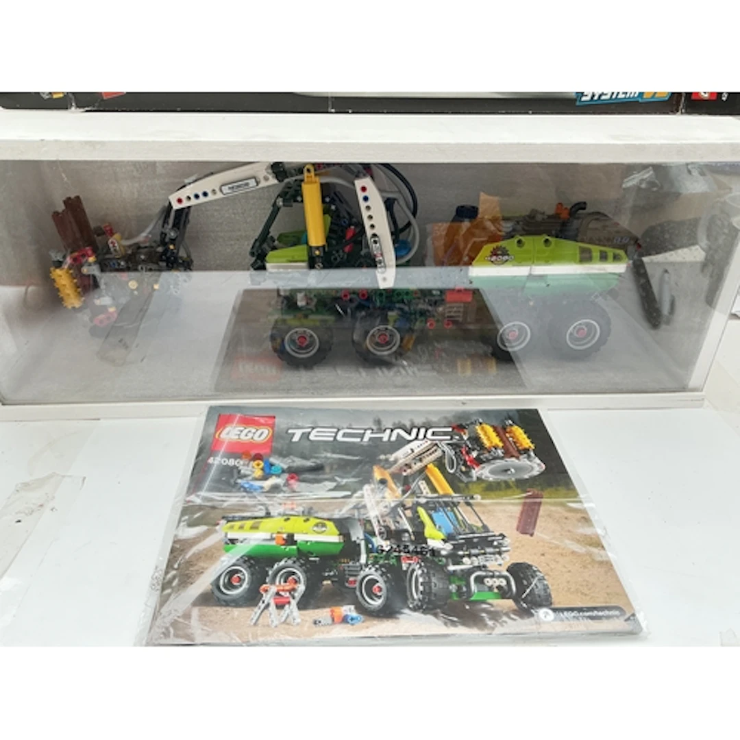A Lego Technic Forest Machine In Display Case #42080 With Ma...