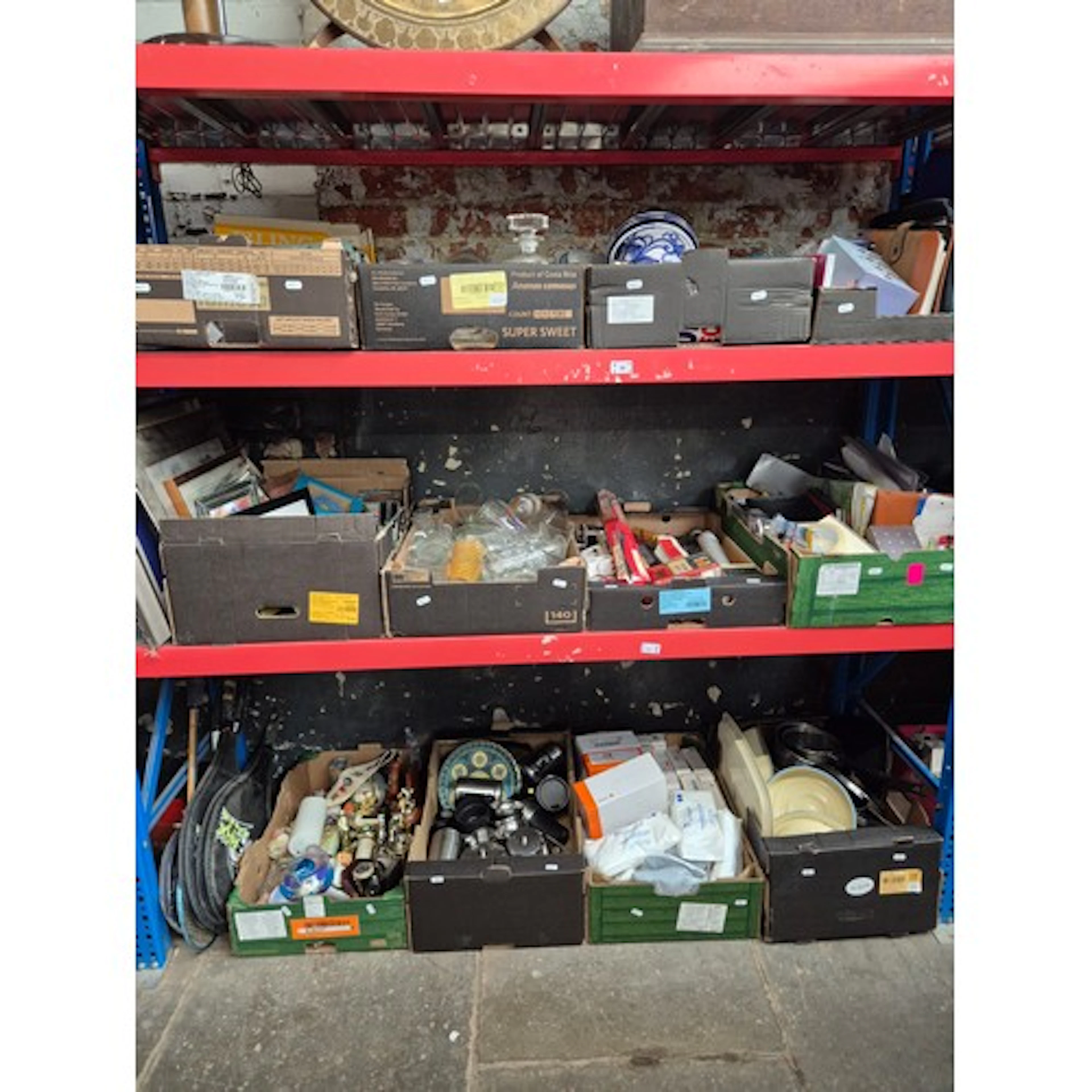 3 shelves containing 12 boxes of mixed items including glass...