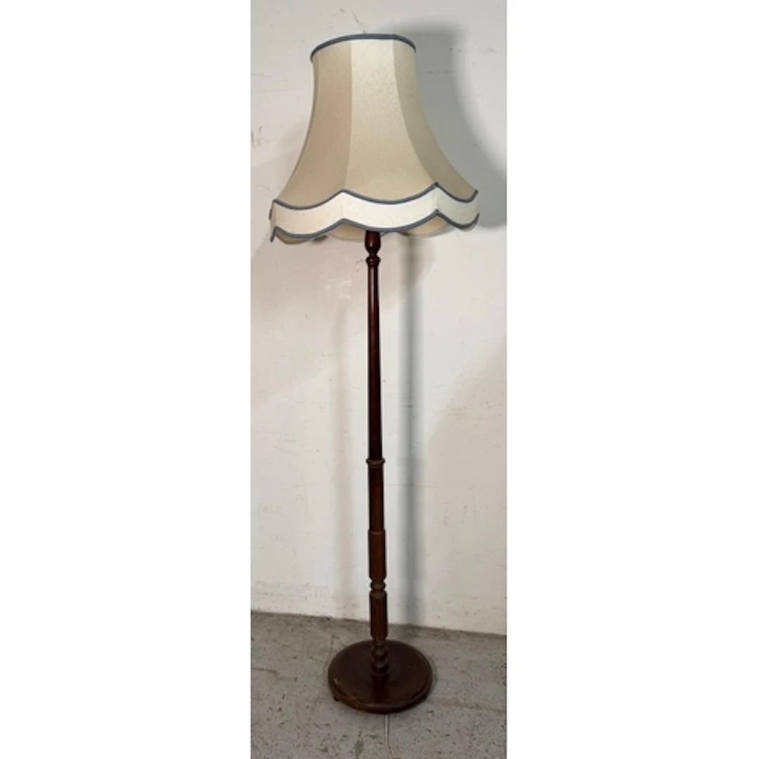 A Mahogany floor standing lamp on a turned column