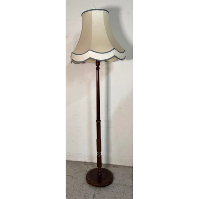 A Mahogany floor standing lamp on a turned column