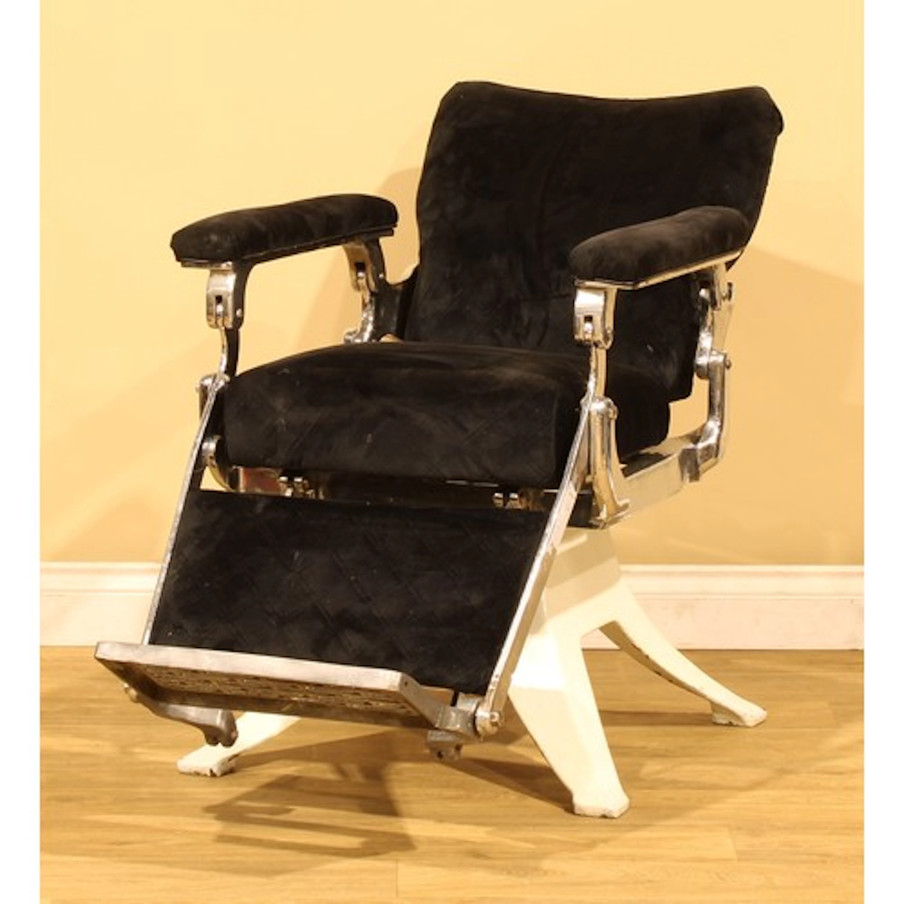 A vintage French barber chair, the footplate cast La Reine, ...