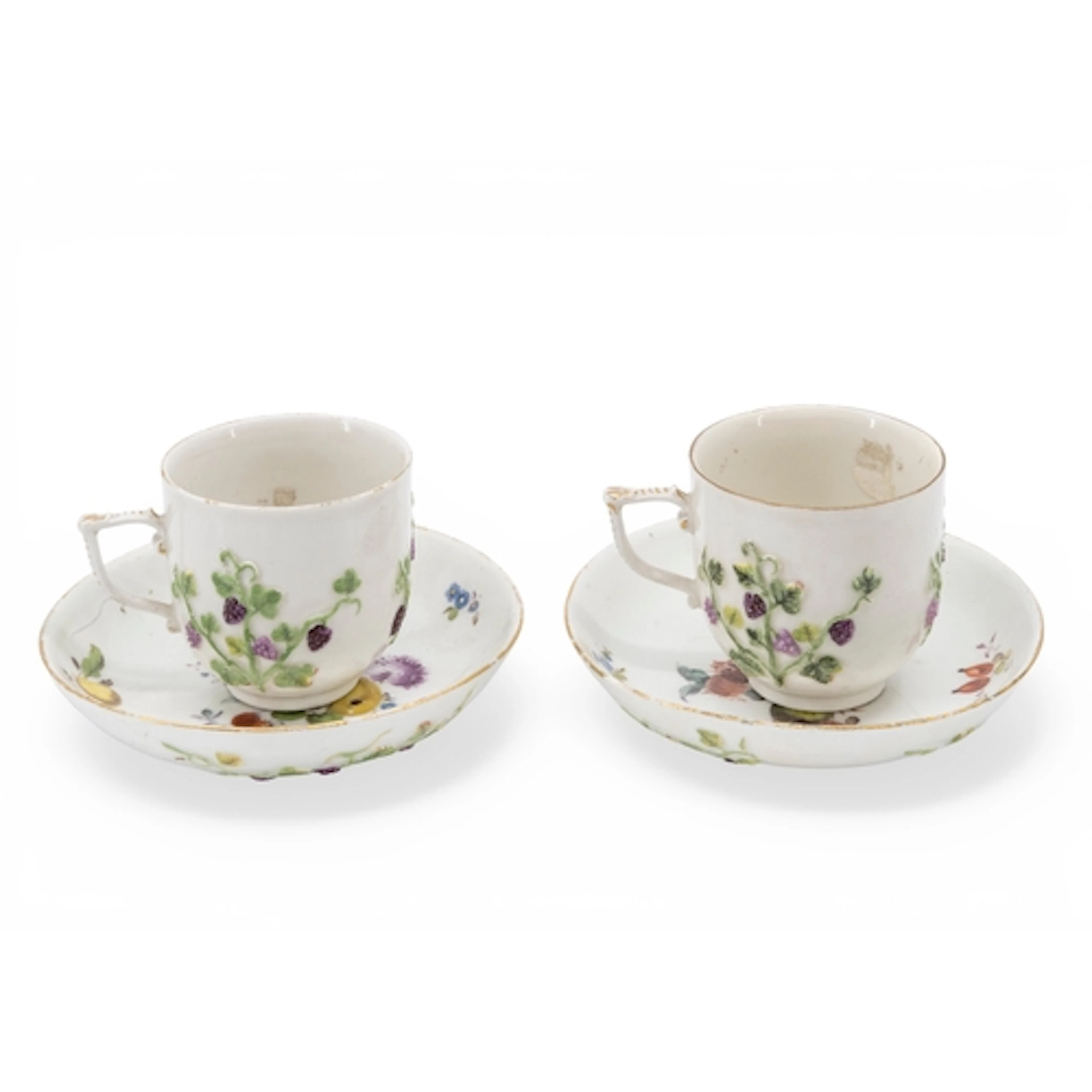 A PAIR OF MEISSEN CABINET CUPS AND SAUCERS decorated with ra...
