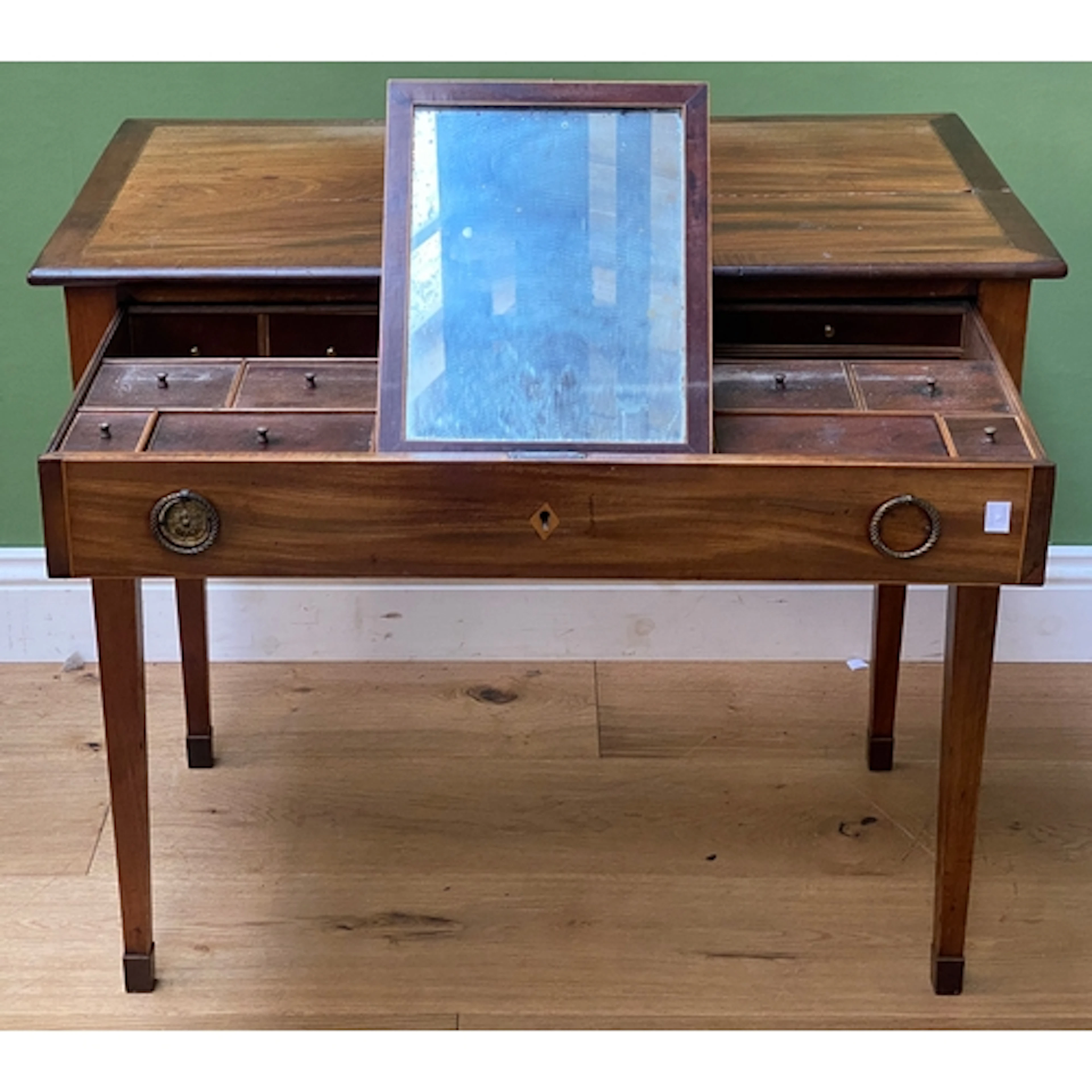A smart early 19th century mahogany dressing table, the cros...