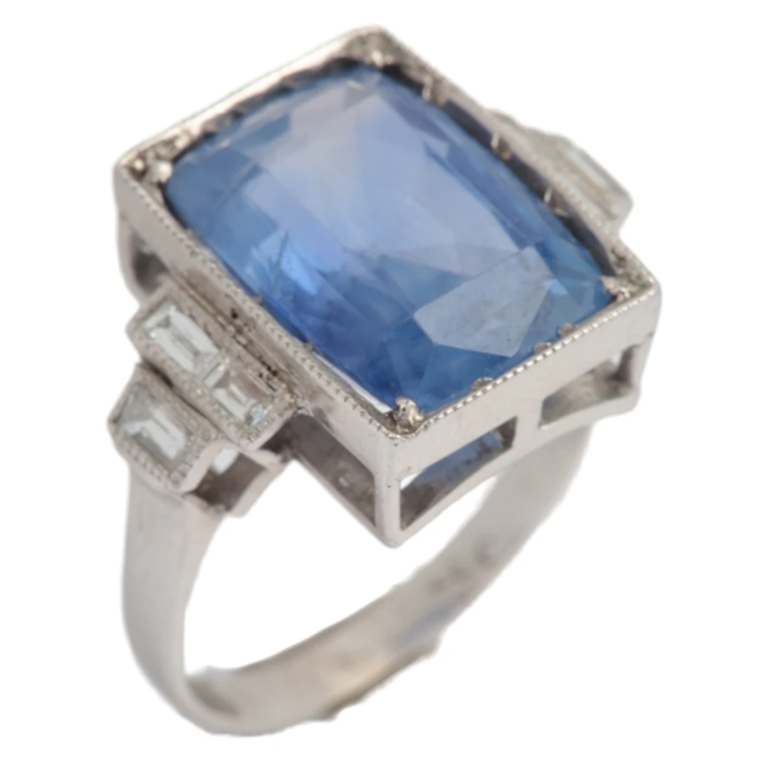 A sapphire and diamond ring, set with a cushion-shaped sapph...