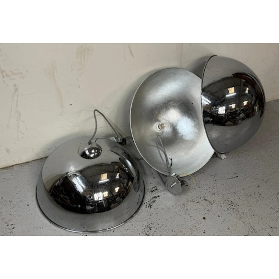 Three industrial style chrome ceiling lights.