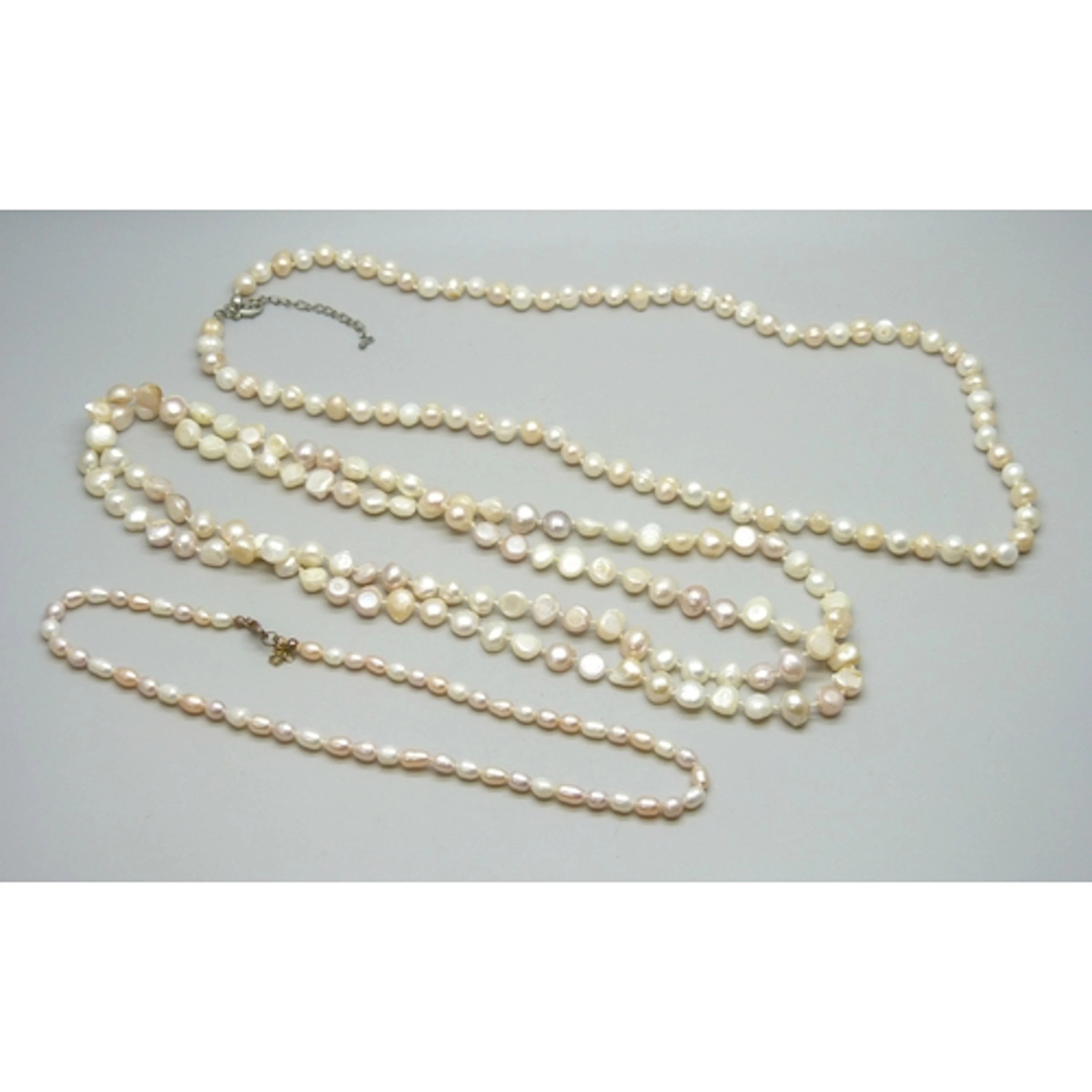 Three pink and white pearl necklaces including an opera leng...