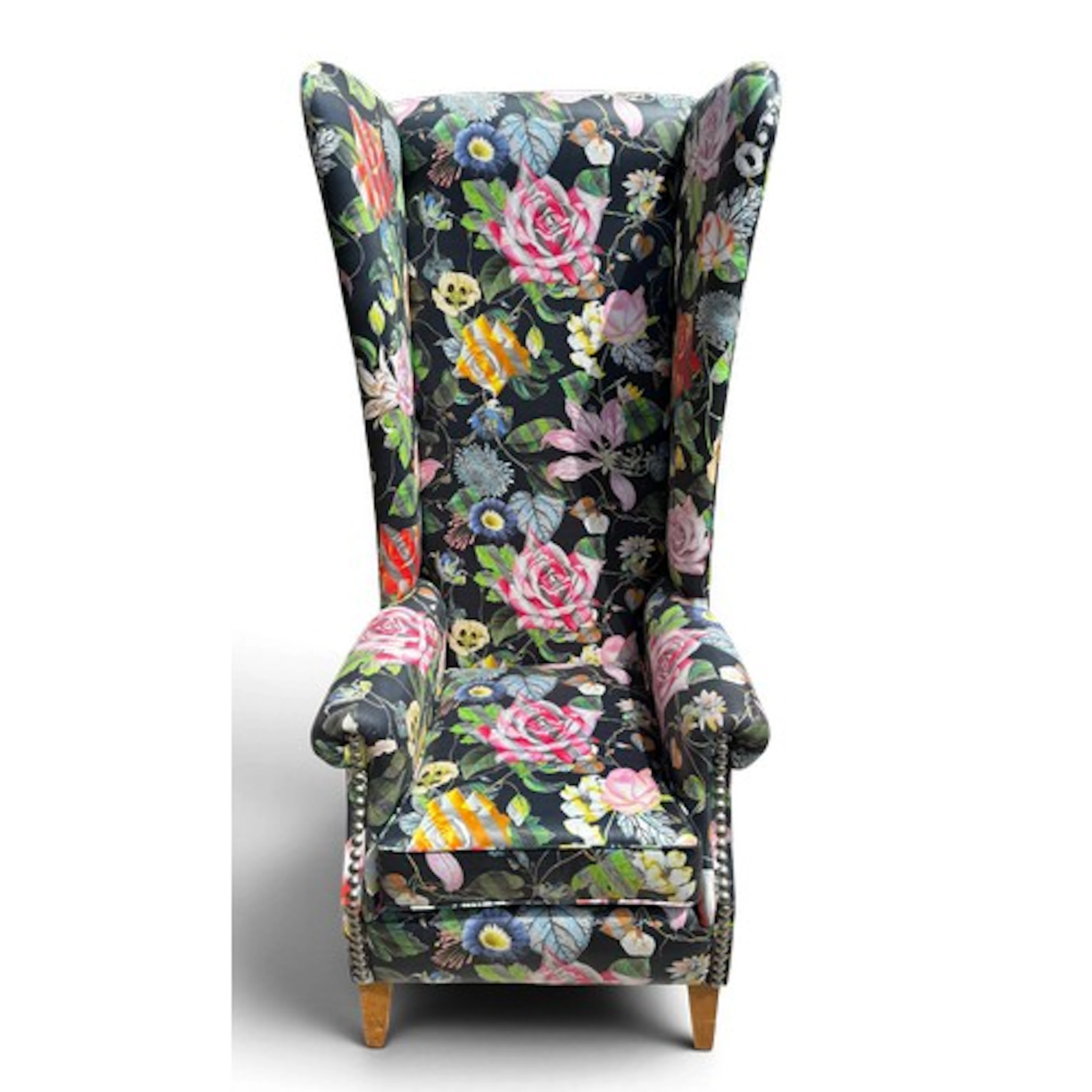 A high backed wing armchair covered in Christian Lacroix fab...