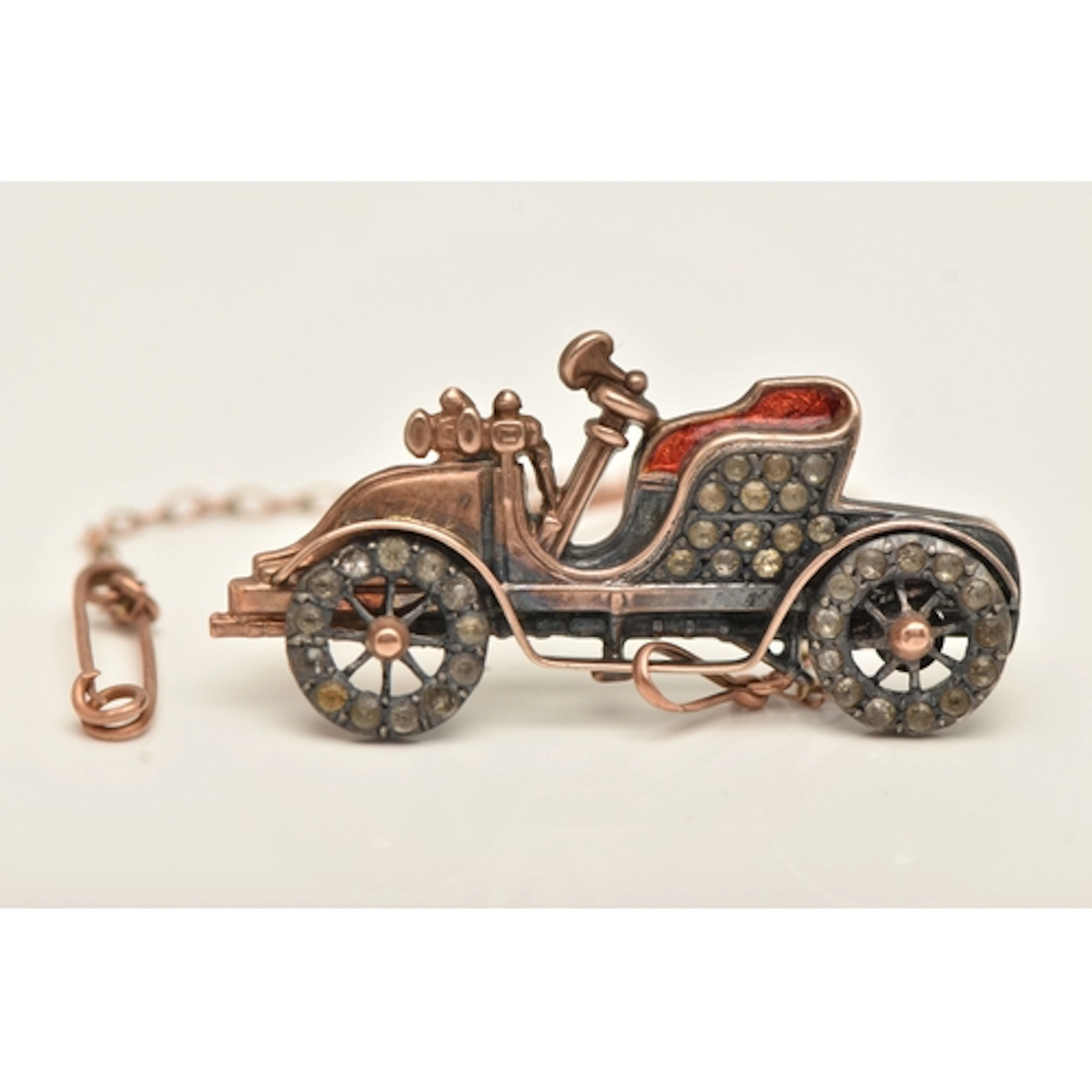 AN EARLY 20TH CENTURY NOVELTY CAR BROOCH, set with paste and...