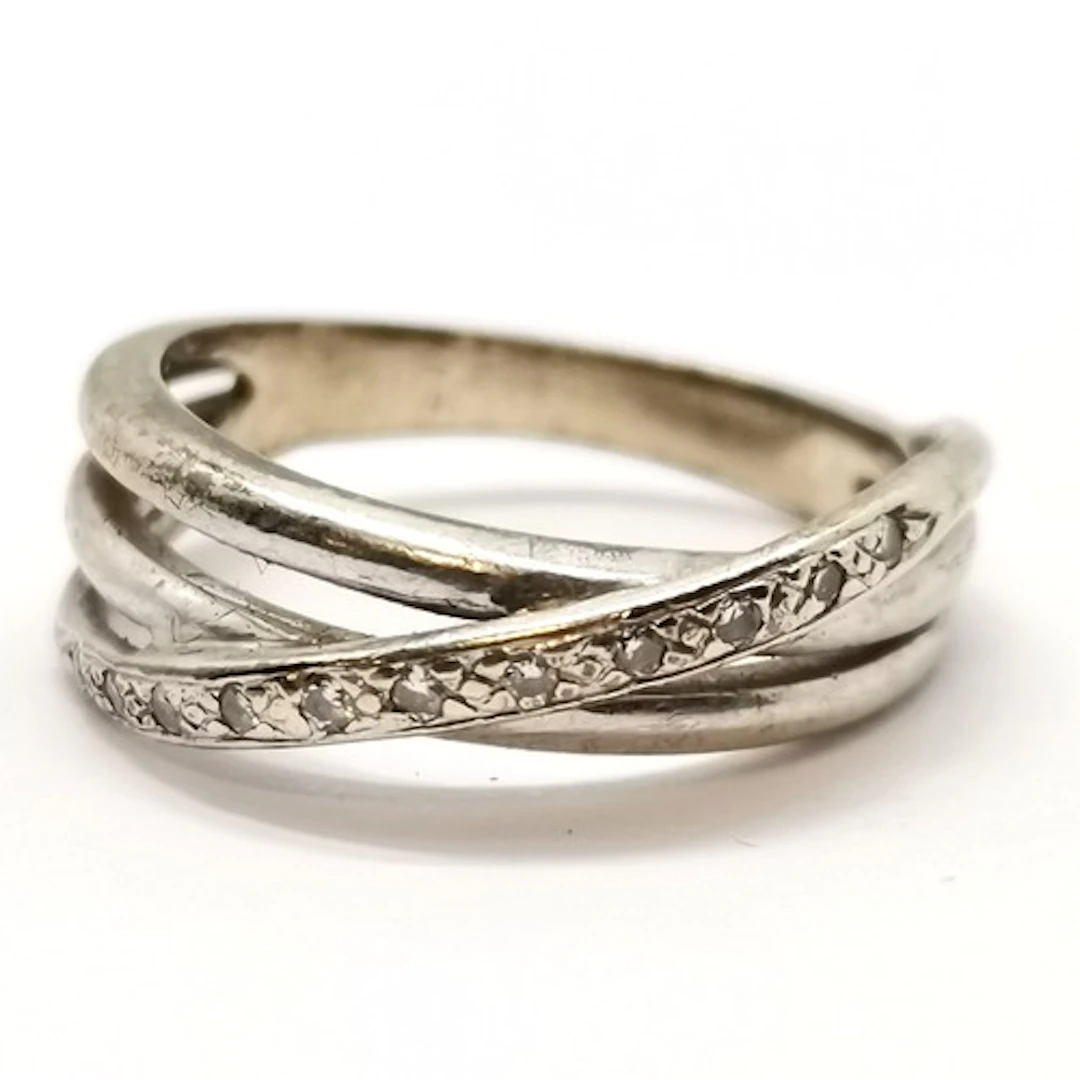 Unmarked white gold diamond set crossover ring - size L & 3g...