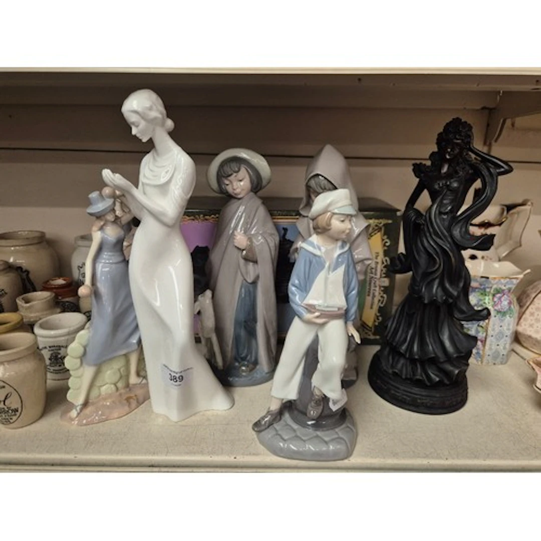A collection of figurines to include Lladro, Nao, Royal Doul...