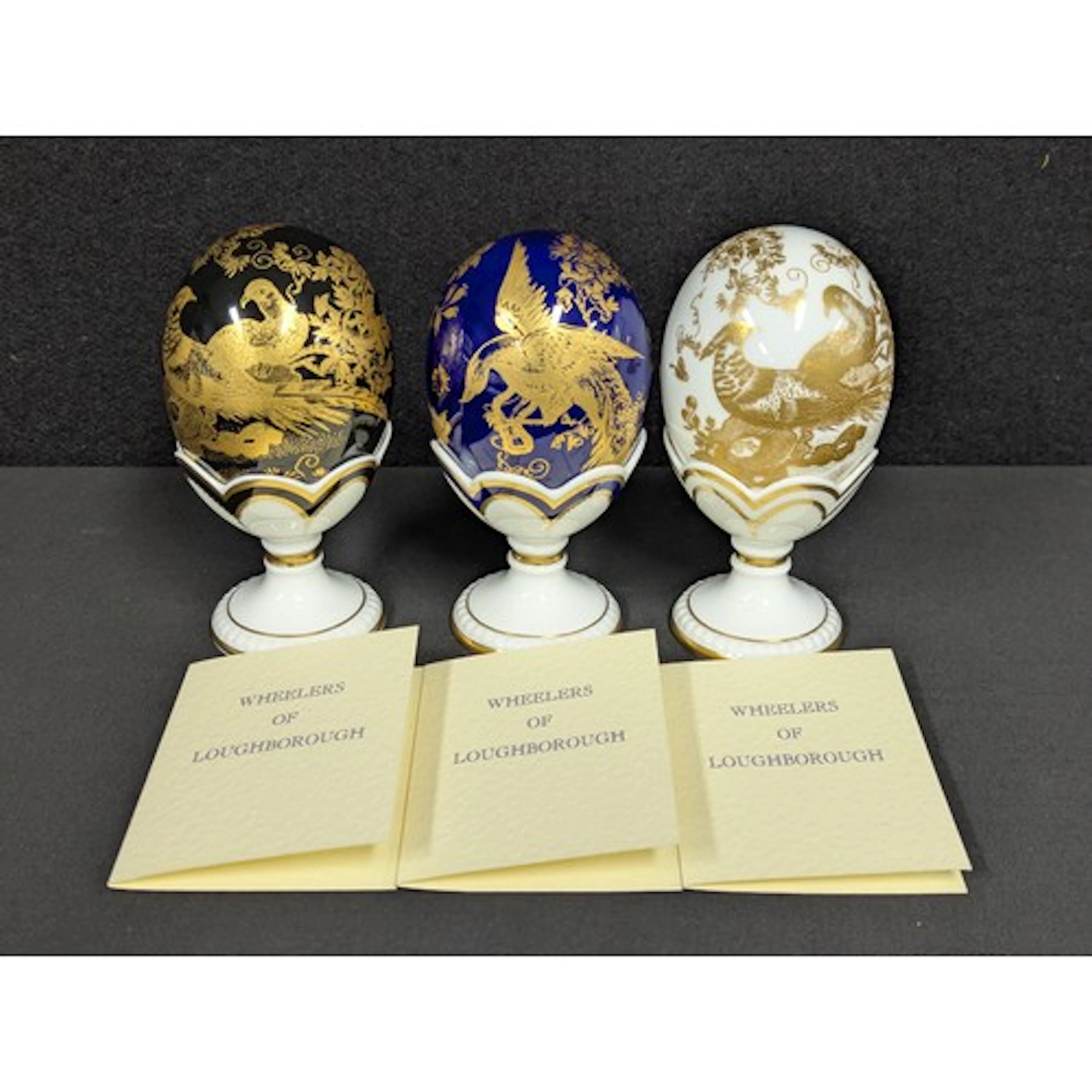 A set of three harlequin Royal Crown Derby "Faberge Eggs" on...