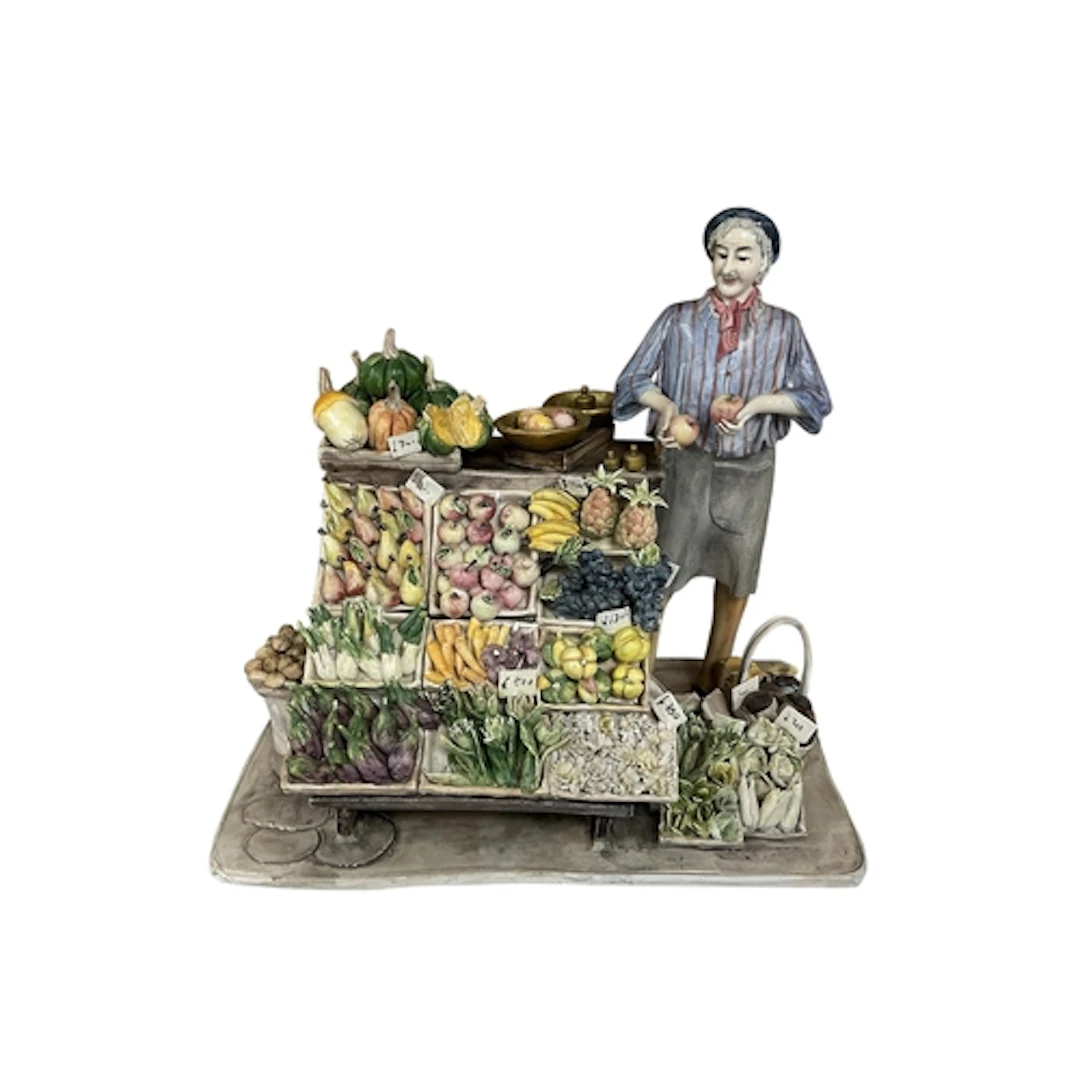 Longo Cerva, The Greengrocer, a painted ceramic figure group...