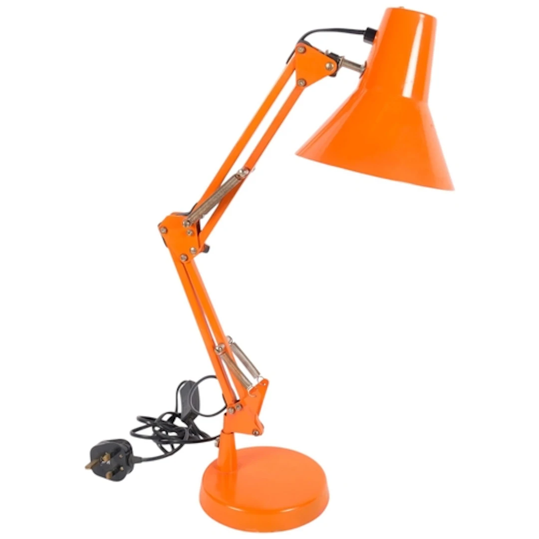 An orange coloured metal anglepoise desk lamp