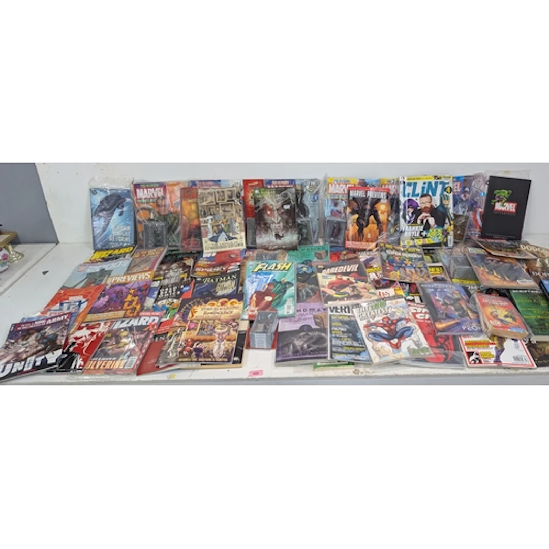 A collection of graphic novels and reference comics, magazin...