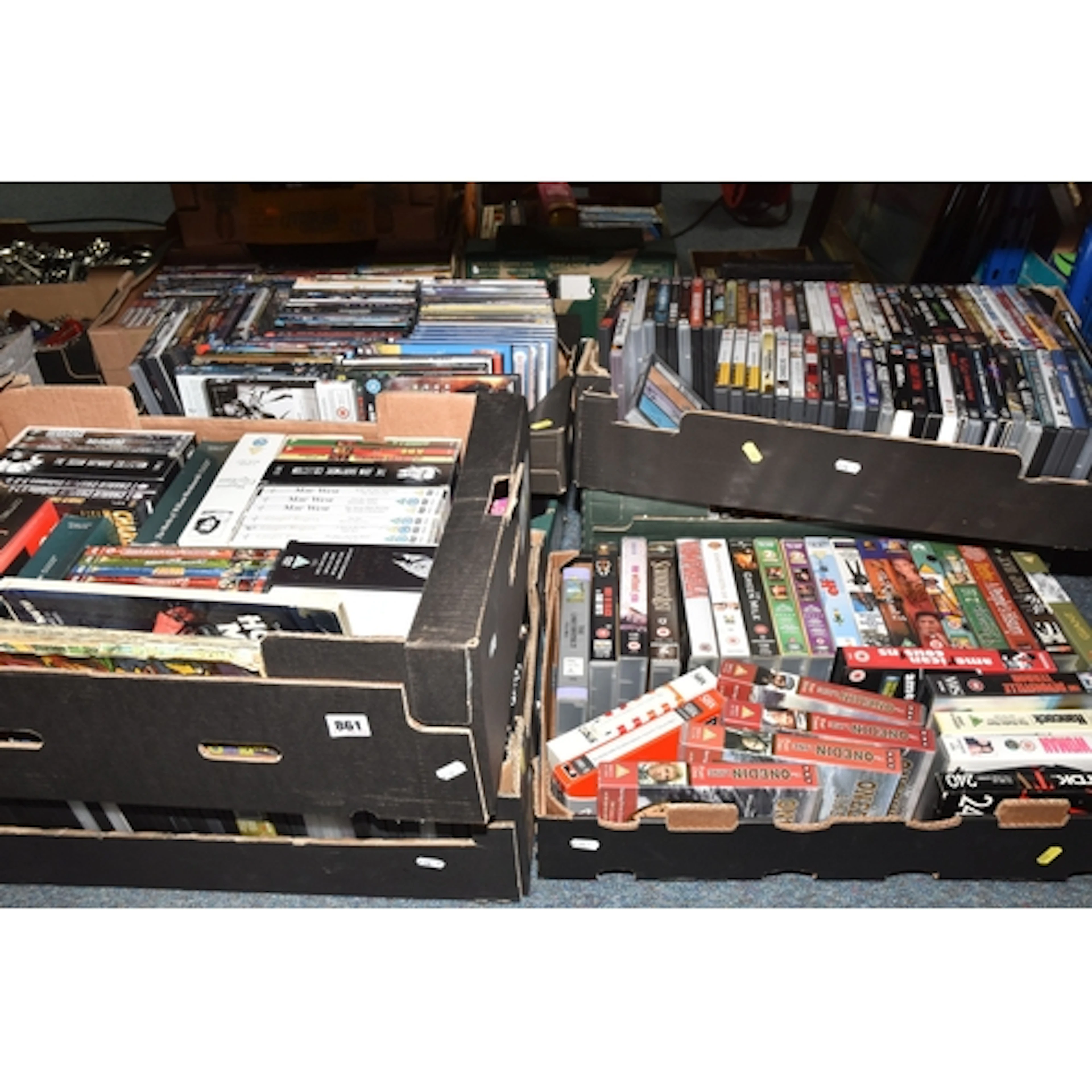 SEVEN BOXES OF VHS AND DVDS to include five boxes of DVDs to...