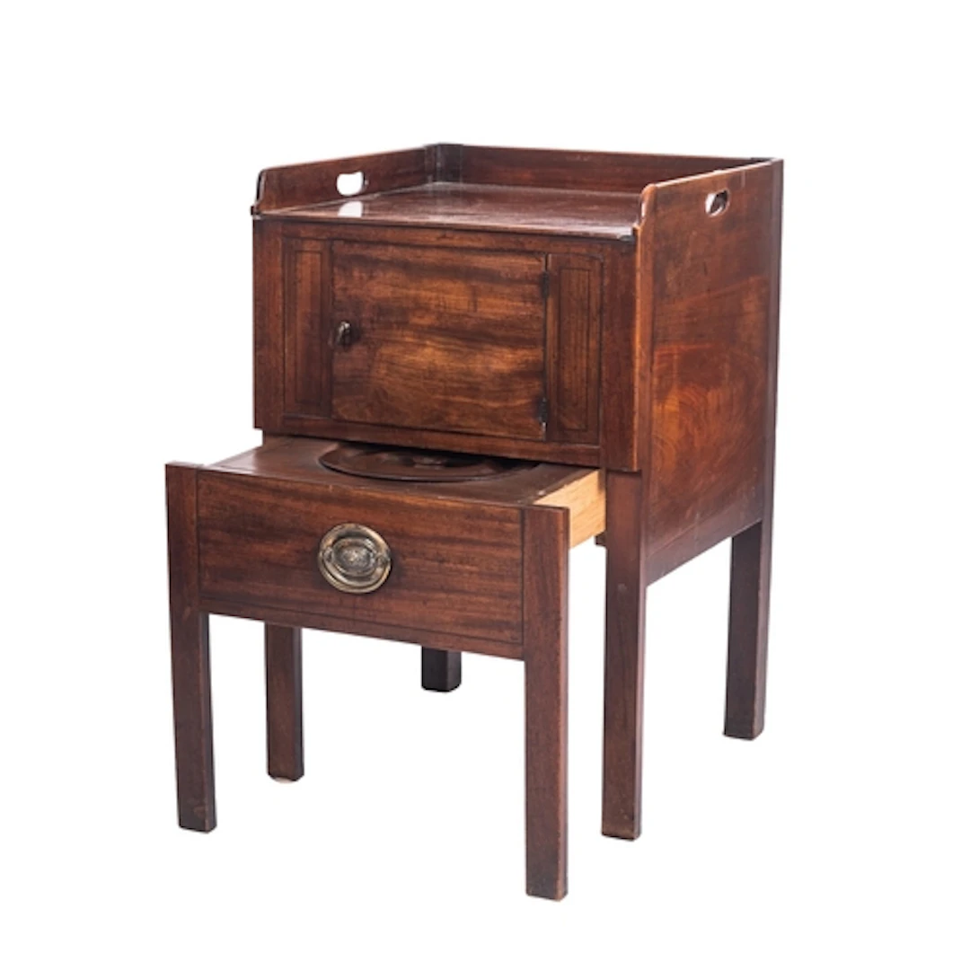A George III mahogany night commode, circa 1800; the three-q...