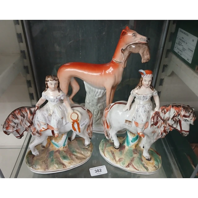 A pair of Staffordshire figures of ladies riding, one side s...