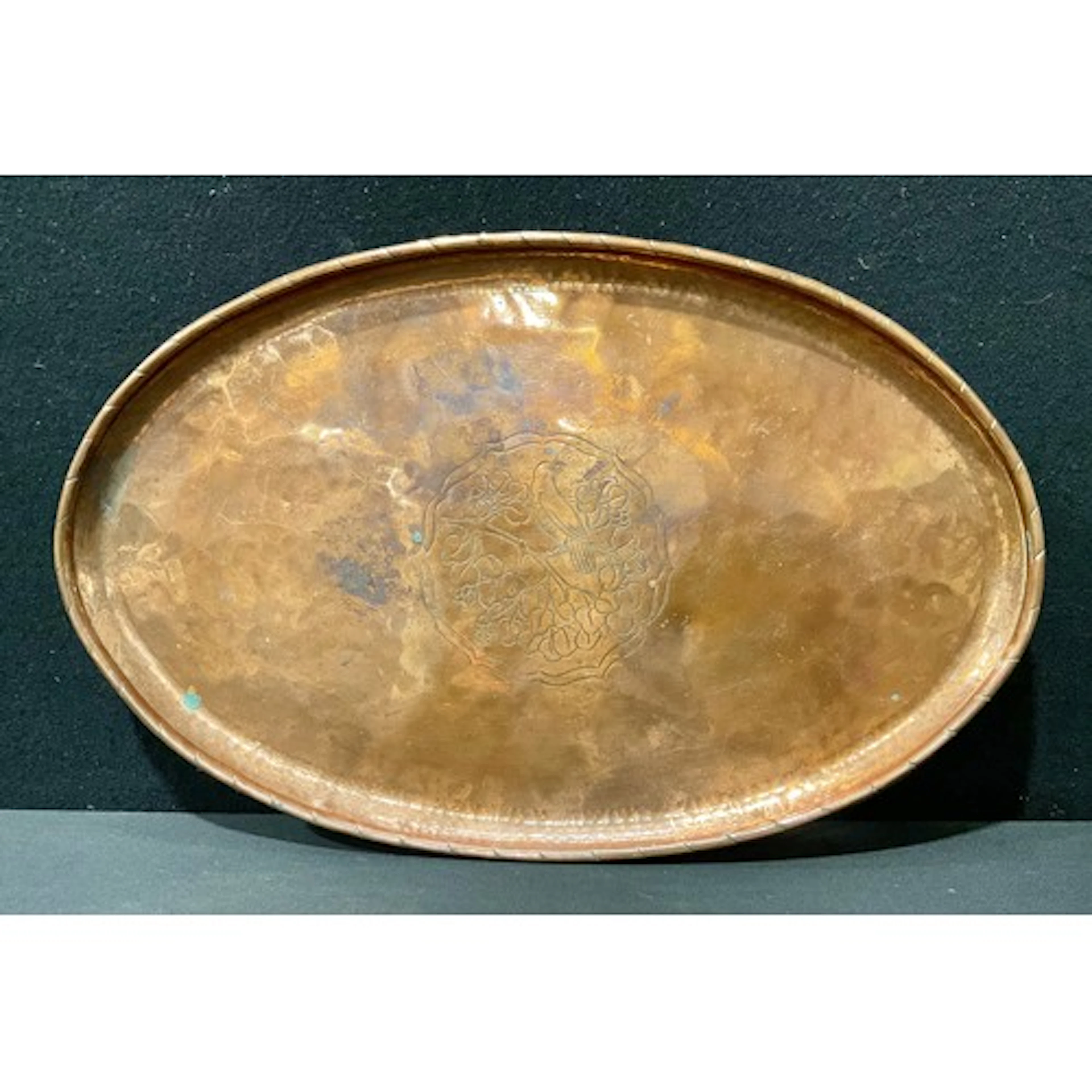 A Hugh Wallis Arts & Crafts copper oval tray, the field chas...