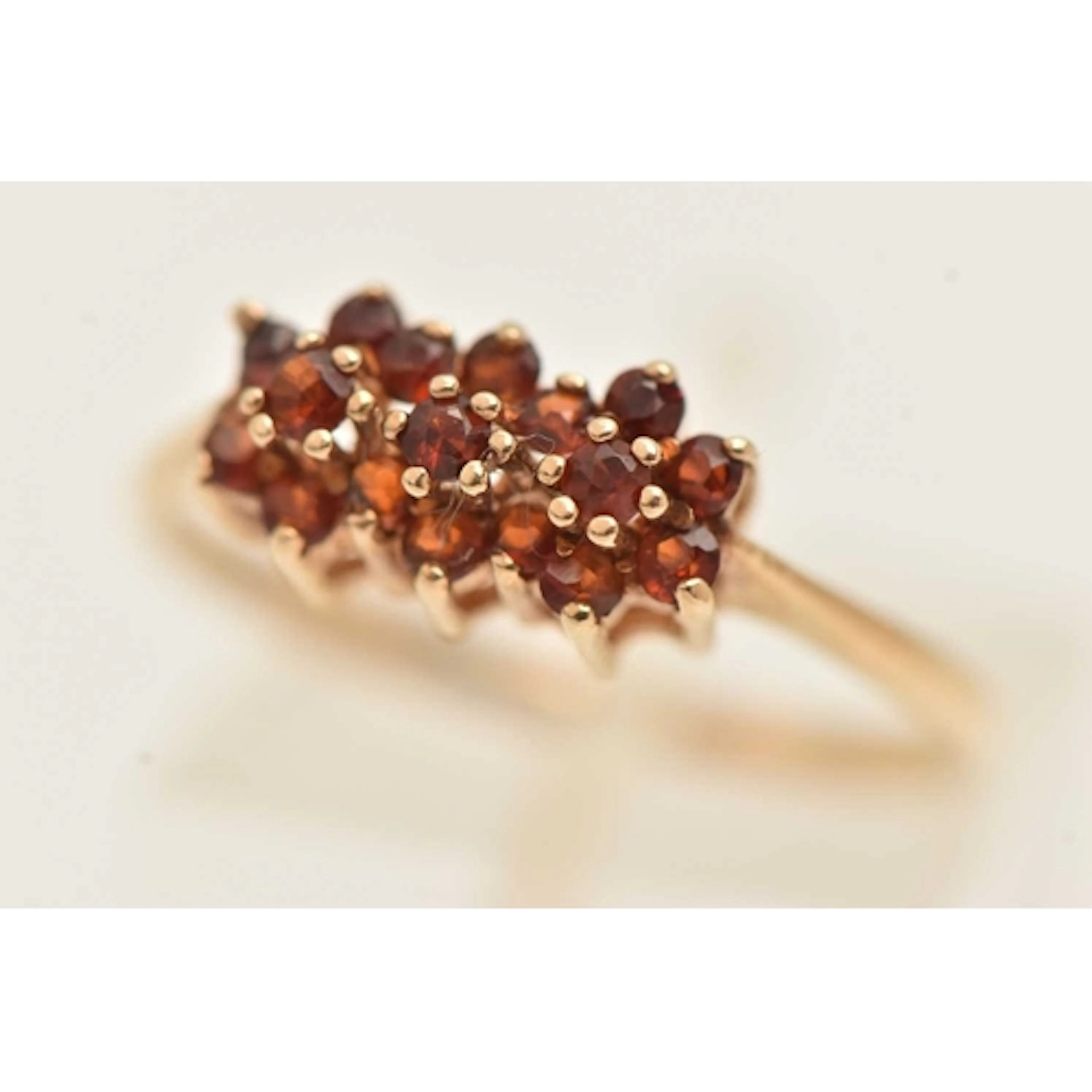 A 9CT GOLD GEM SET CLUSTER RING, designed as three rows of c...